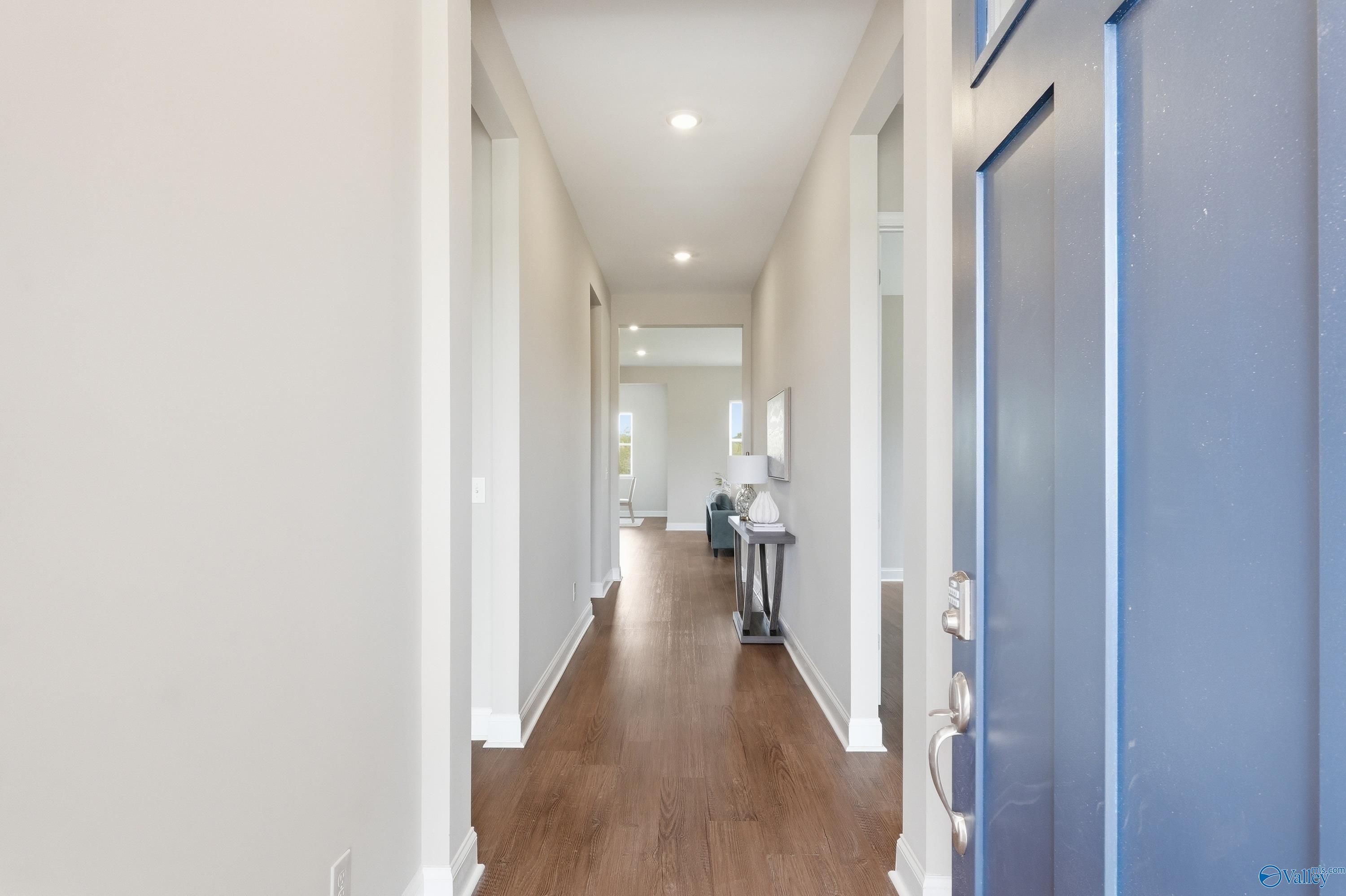 Elegant hallway with hardwood floors, beige walls, and recessed lights in The Arcadia B 4-bedroom home, Riverton Preserve, Huntsville