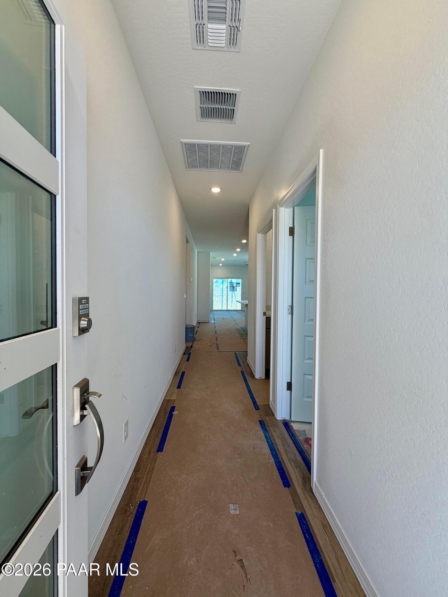 Entry hallway with glass-panel front door and keypad lock under construction at Davidson Homes Marietta C, Prescott, AZ