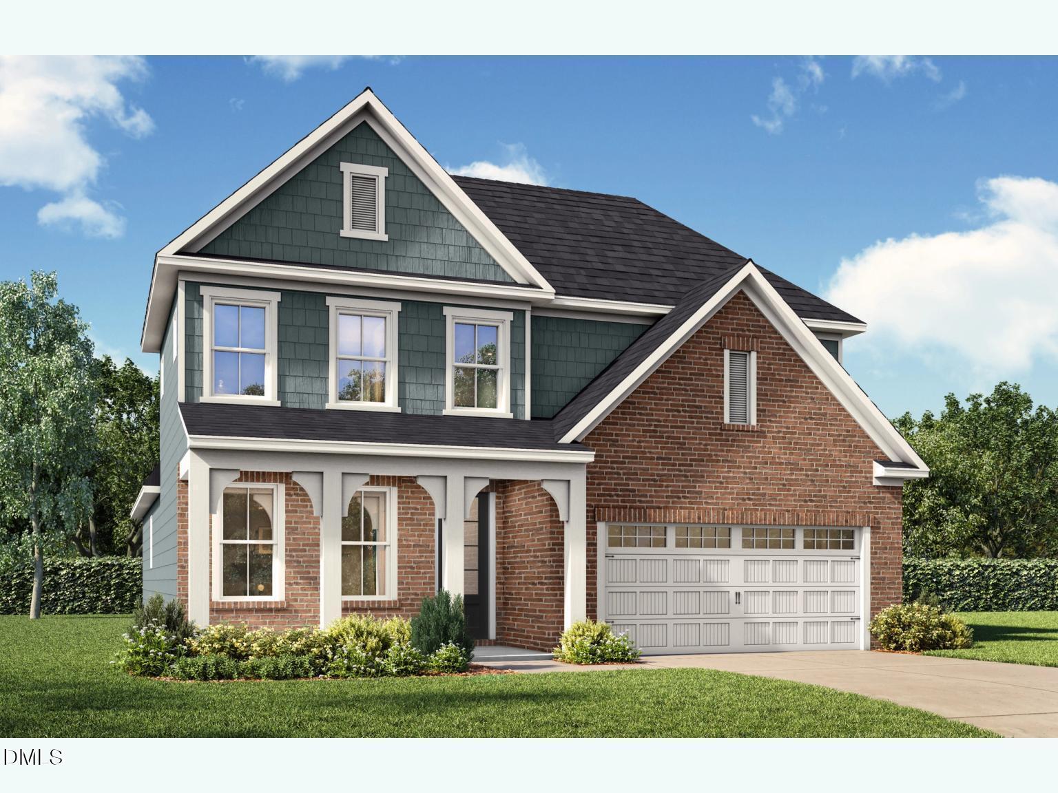 Two-story Ashport G home with sage green siding, brick accents, two-car garage, and landscaped yard in Wake Forest, NC