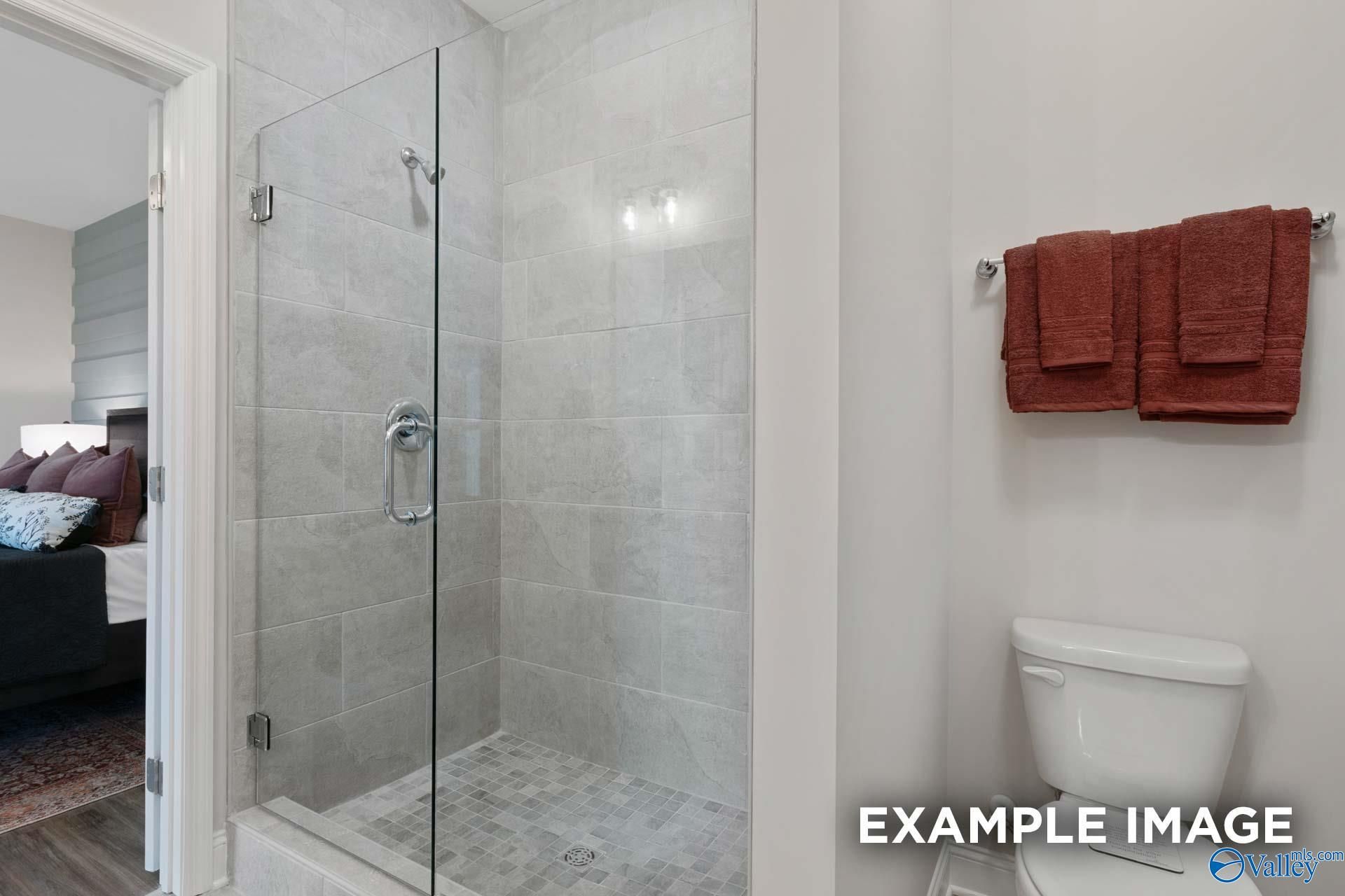 Frameless glass walk-in shower with gray tile in Davidson Homes Camilla C bathroom, The Retreat at Cain Park, Hartselle AL