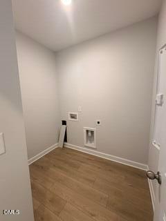 Dedicated laundry room with wood-style flooring in The Daphne D floor plan by Davidson Homes in Zebulon, North Carolina.
