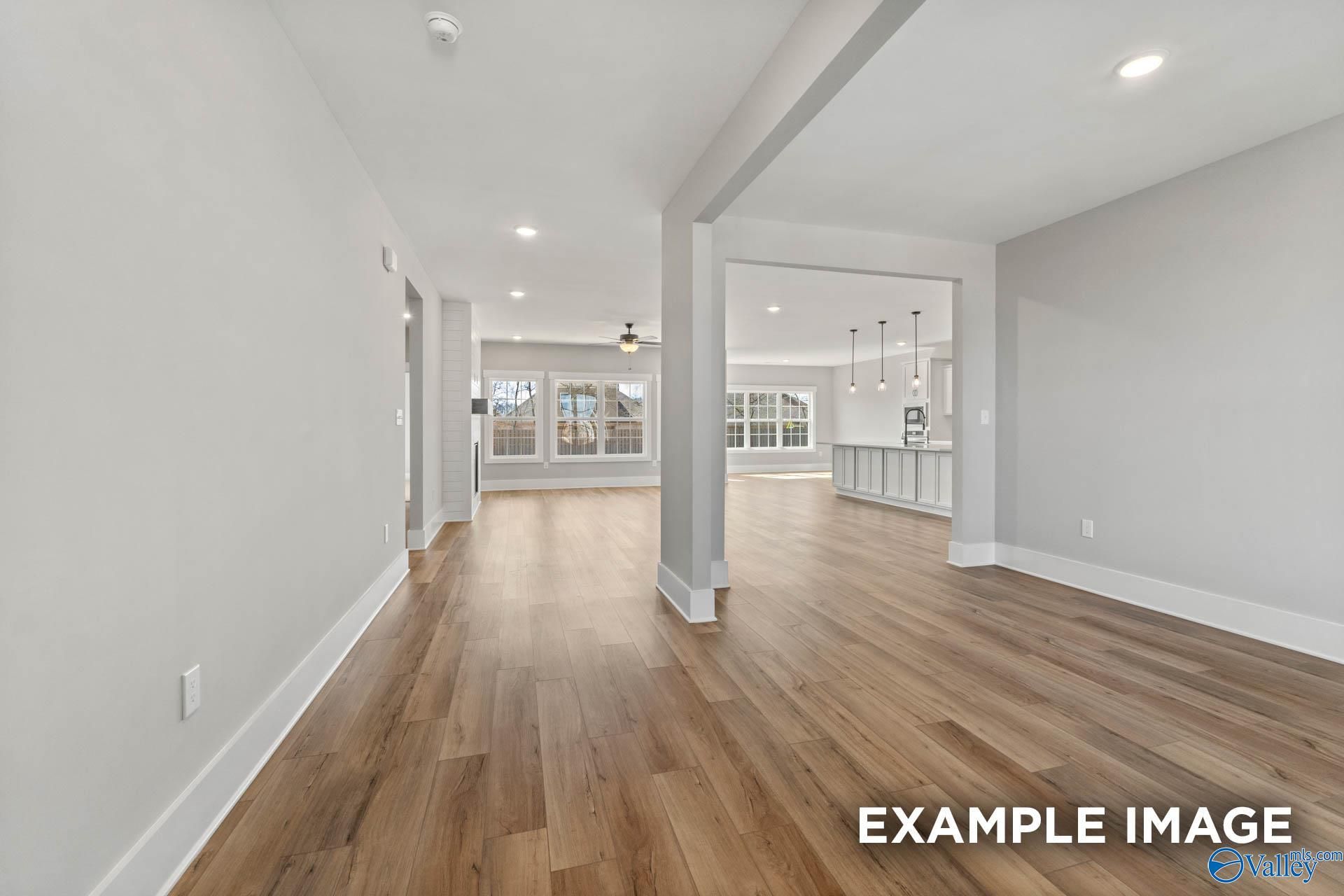 Open-concept living area with hardwood floors in The Finleigh floor plan by Davidson Homes in Briercreek, Meridianville.