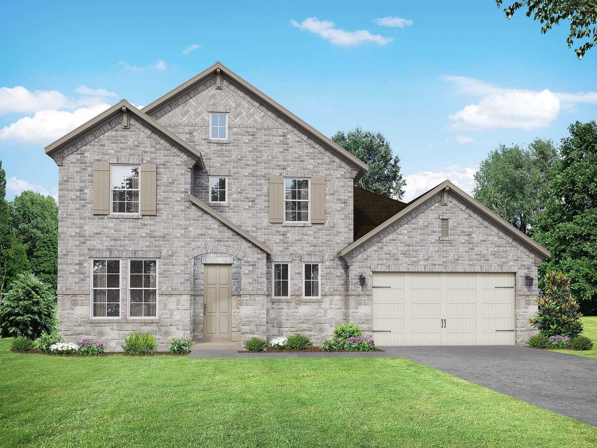 Modern two-story brick home with gabled roof, 2-car garage, driveway, and lush green lawn in Sierra Vista, Rosharon, Texas