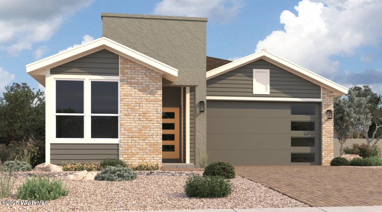 Modern single-story 3-bedroom home with brick facade, gray garage, large windows, desert landscaping in Prescott, AZ Davidson Homes Newport C