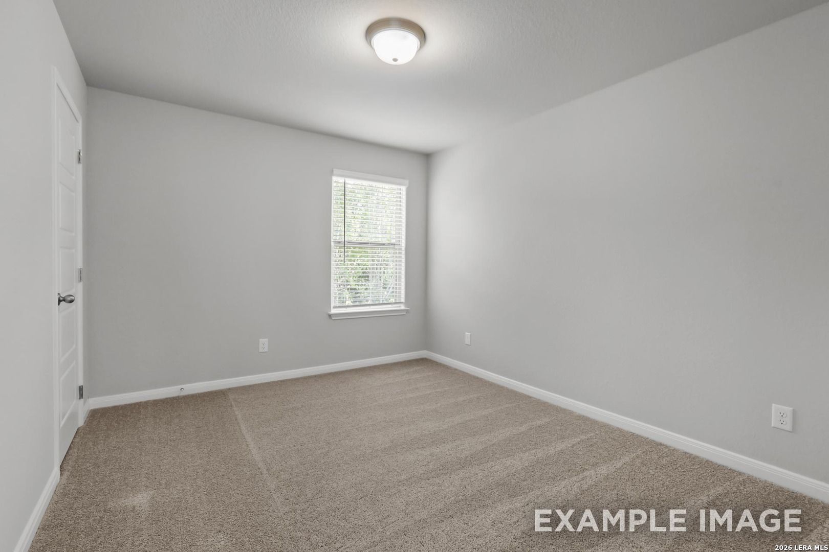 Spacious secondary bedroom with neutral gray walls and plush carpet in The Gillian A floor plan, Cedar Heights, San Antonio.