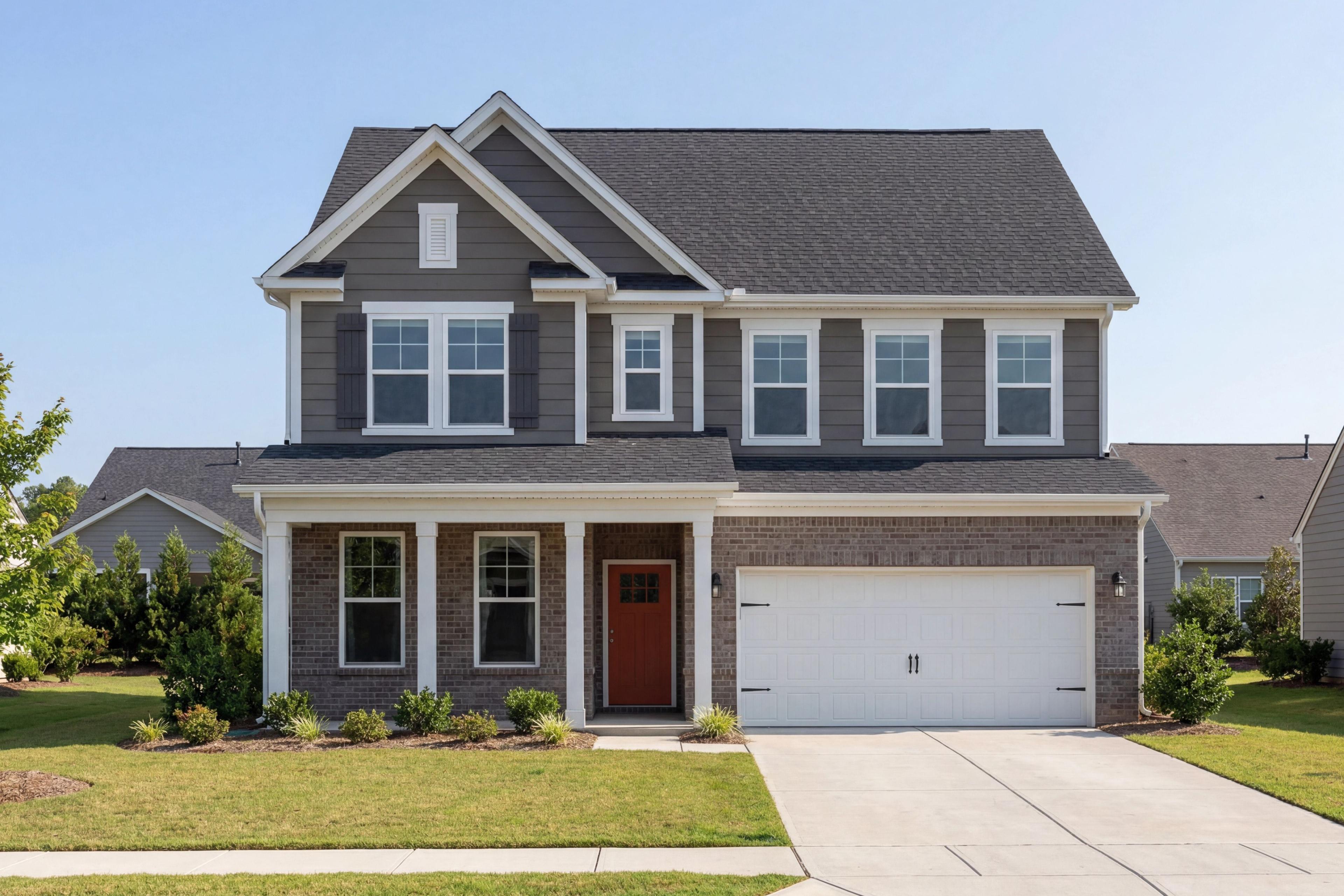 Modern two-story Chestnut C home exterior by Davidson Homes in Wendell NC with gray siding, red door, porch, and two-car garage
