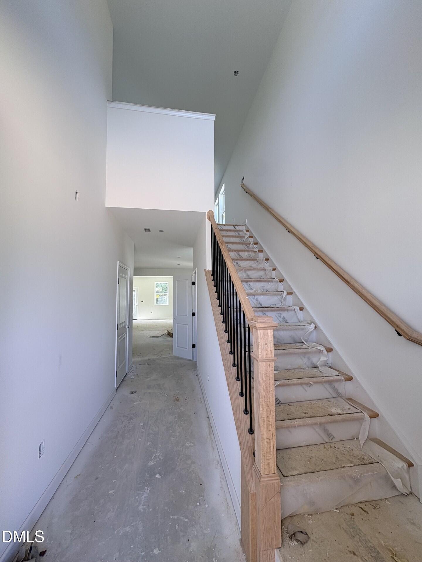Two-story foyer with oak staircase and wrought iron balusters in new Davidson Homes Adalynn A plan, Zebulon NC