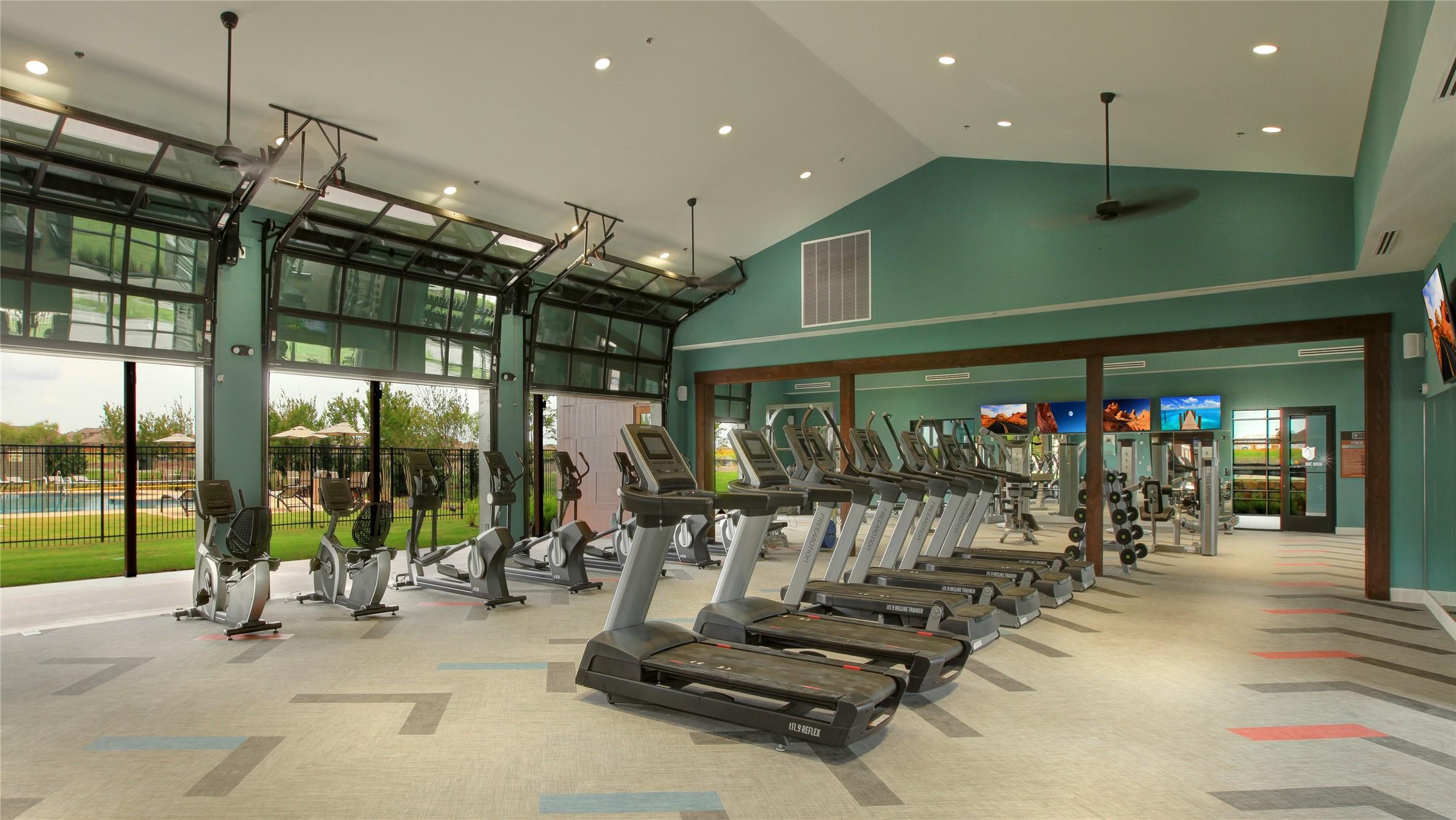 Modern fitness center with treadmills and exercise equipment at Heartland community in Heartland, Texas.
