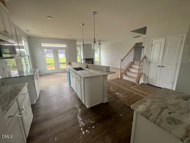 Open-concept kitchen and living area with kitchen island in The Ash B floor plan at Retreat at North Main, Lillington, NC.