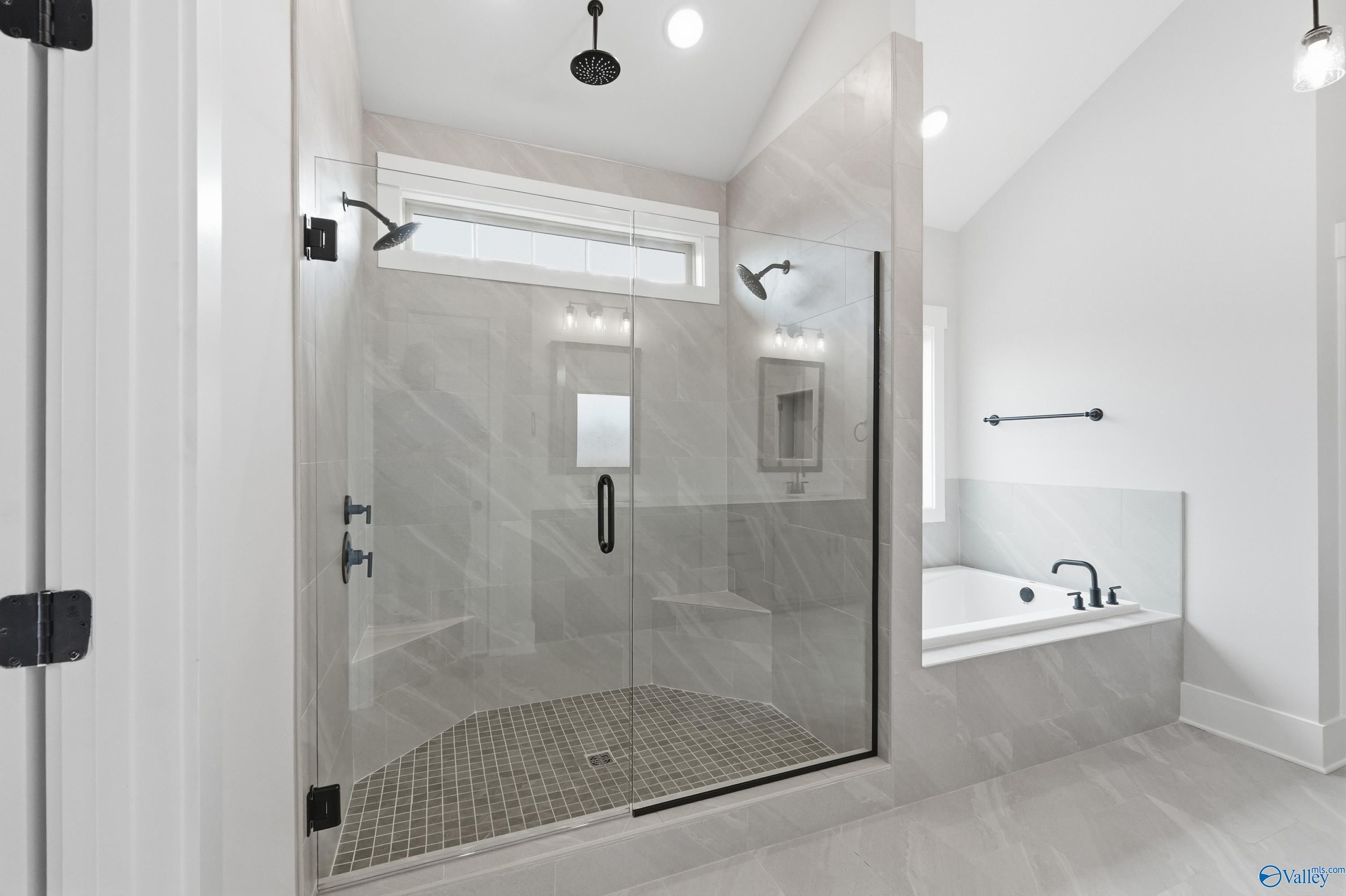 Luxurious master bath with frameless glass shower and freestanding tub in Davidson Homes The Finleigh, Meridianville, Alabama