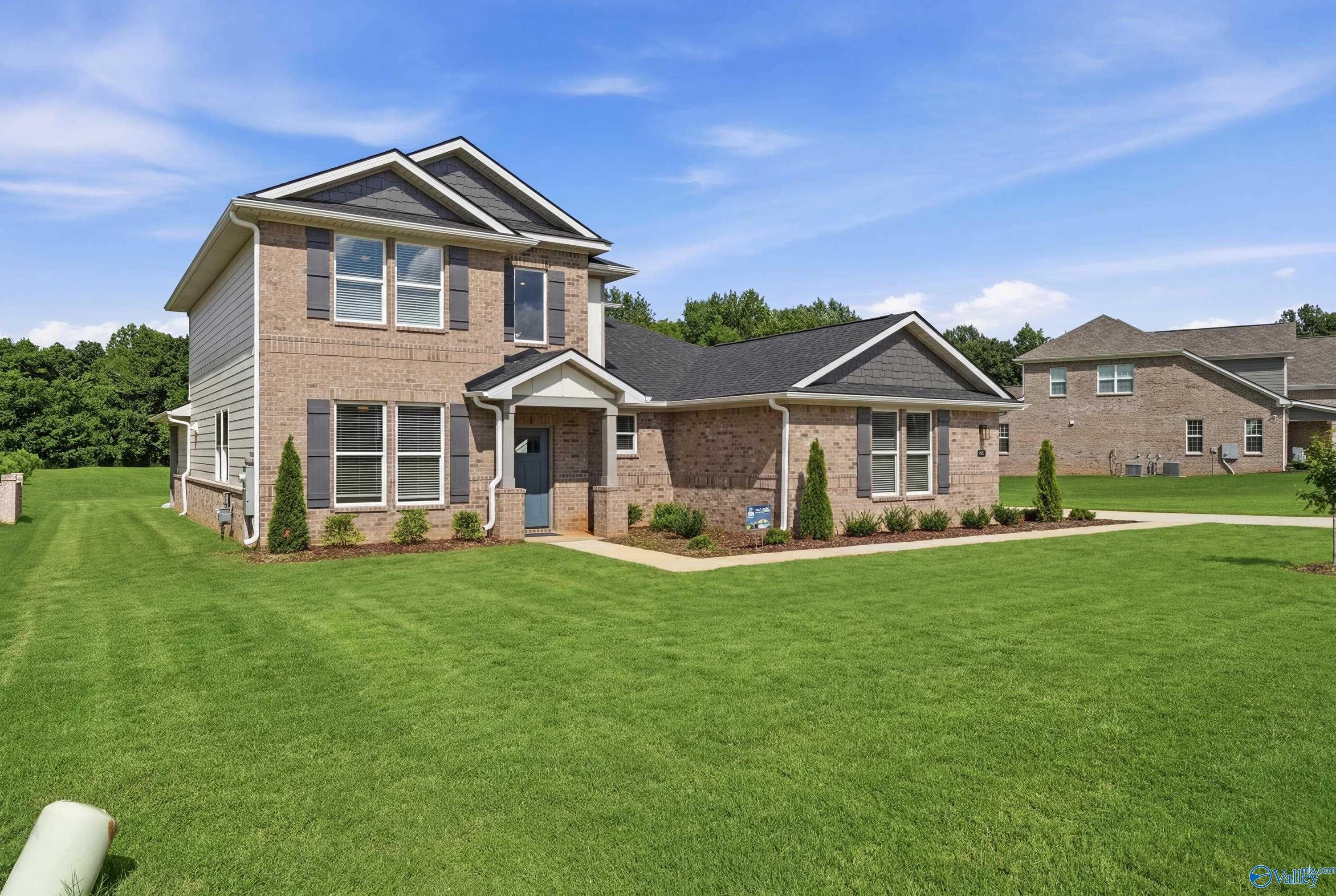 Two-story brick exterior of The Dorado floor plan by Davidson Homes in Riverton Preserve, Huntsville, Alabama.