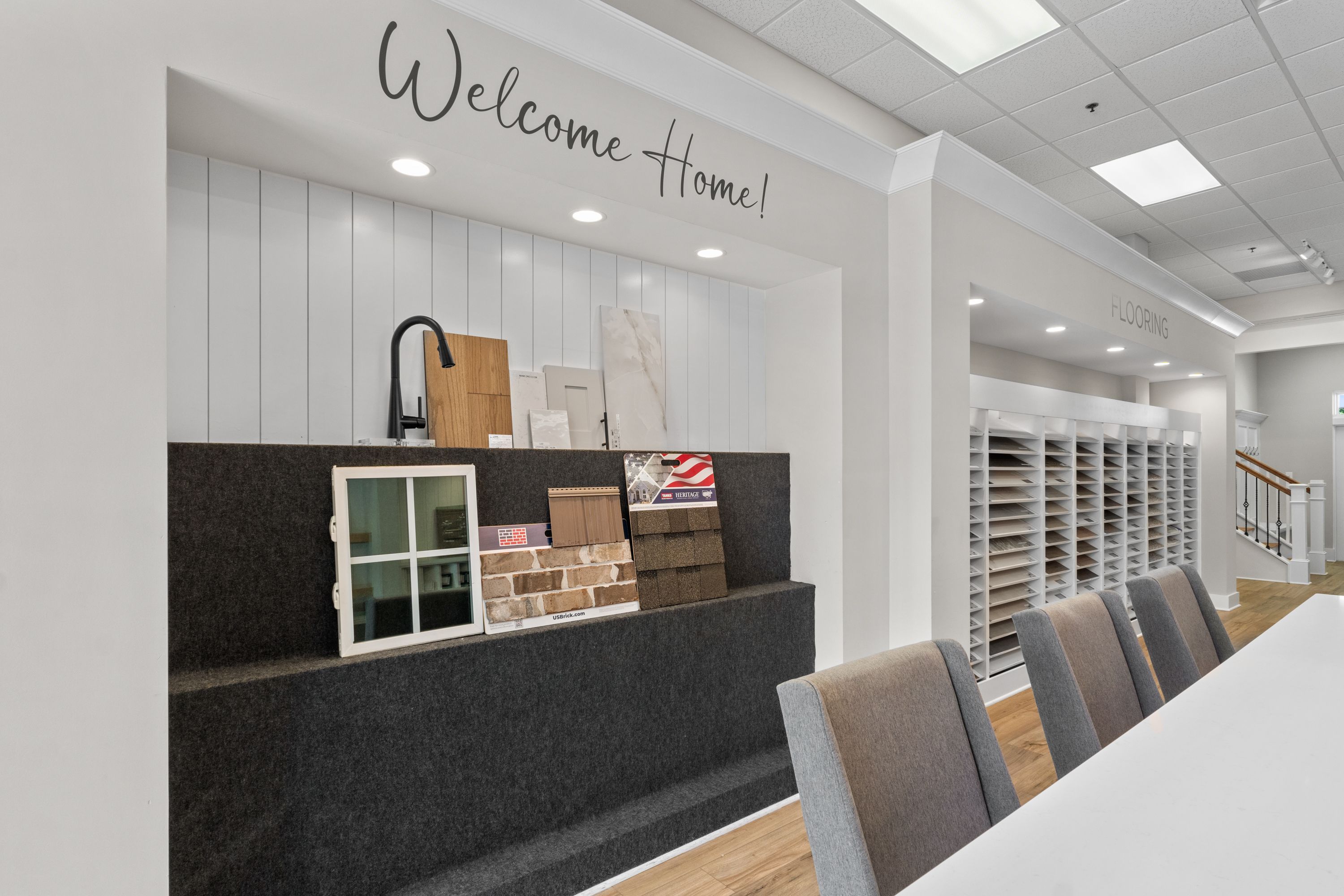 Davidson Homes design center featuring home finish samples, flooring options, and Welcome Home signage for new construction.
