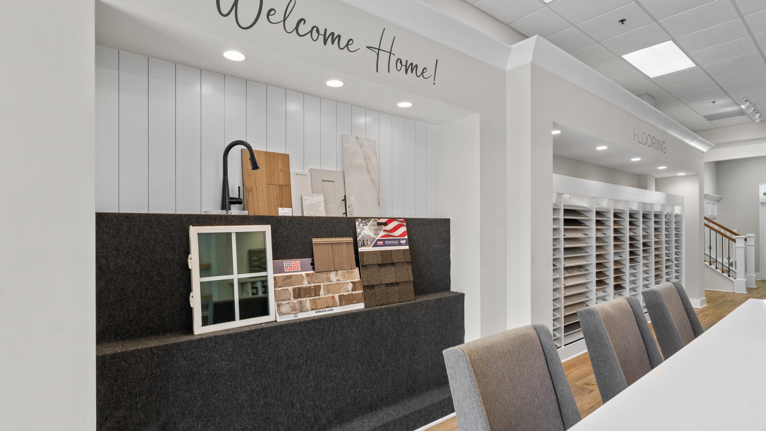 Davidson Homes design center featuring home finish samples, flooring options, and Welcome Home signage for new construction.