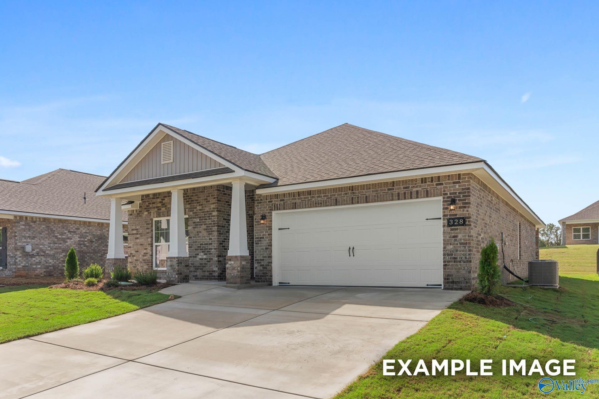 1-story brick home with gabled roof, columned front porch, 2-car garage, and lush landscaping in Walker's Hill, Meridianville, Alabama - Davidson Homes Daphne D