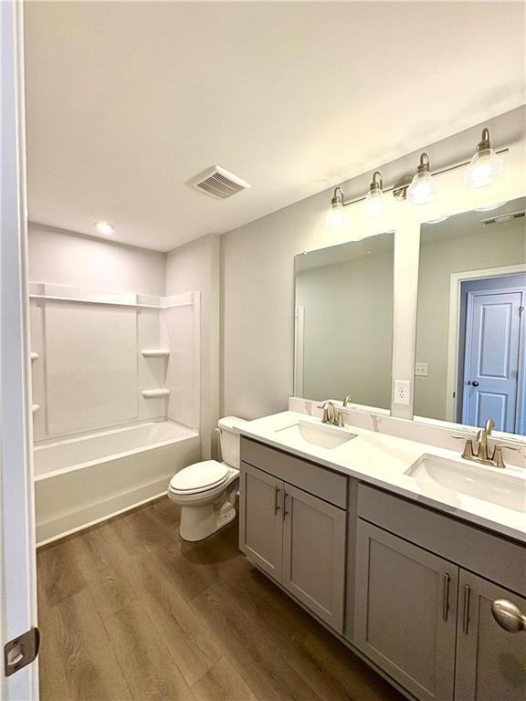 Modern bathroom with double vanity, gray cabinets, tub-shower combo in Davidson Homes The Monroe A, Emerson, GA