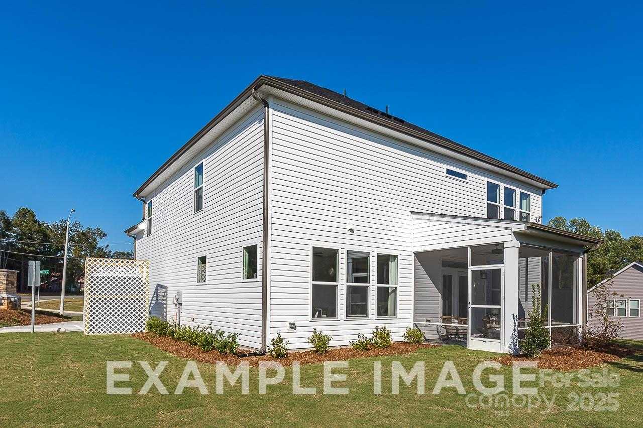 Two-story white-sided home with screened porch, manicured lawn in Enclave at Belmont, Davidson Homes The Hemlock A