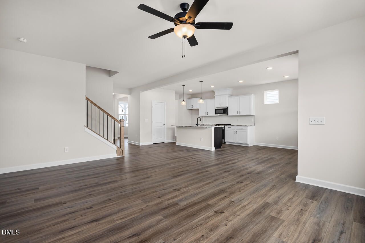 Open-concept living room and kitchen in The Willow B floor plan by Davidson Homes at Woodland Crossing, Zebulon, NC.