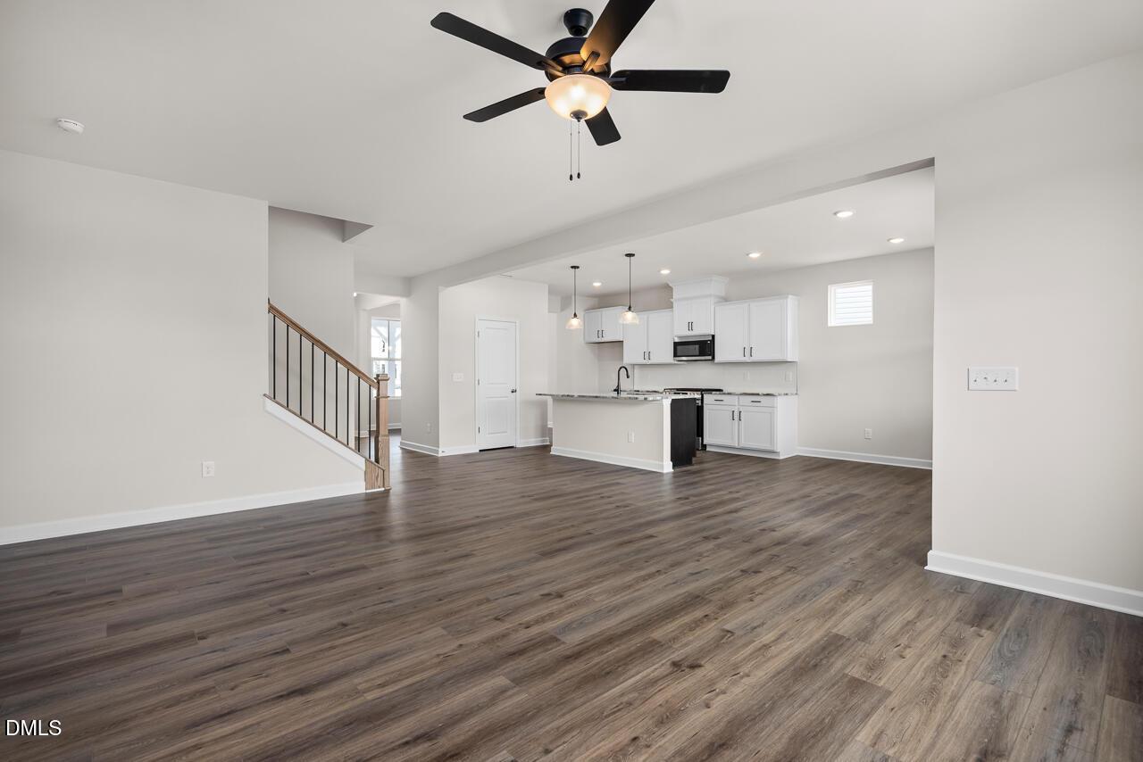 Open-concept living room and kitchen in The Willow B floor plan by Davidson Homes at Woodland Crossing, Zebulon, NC.