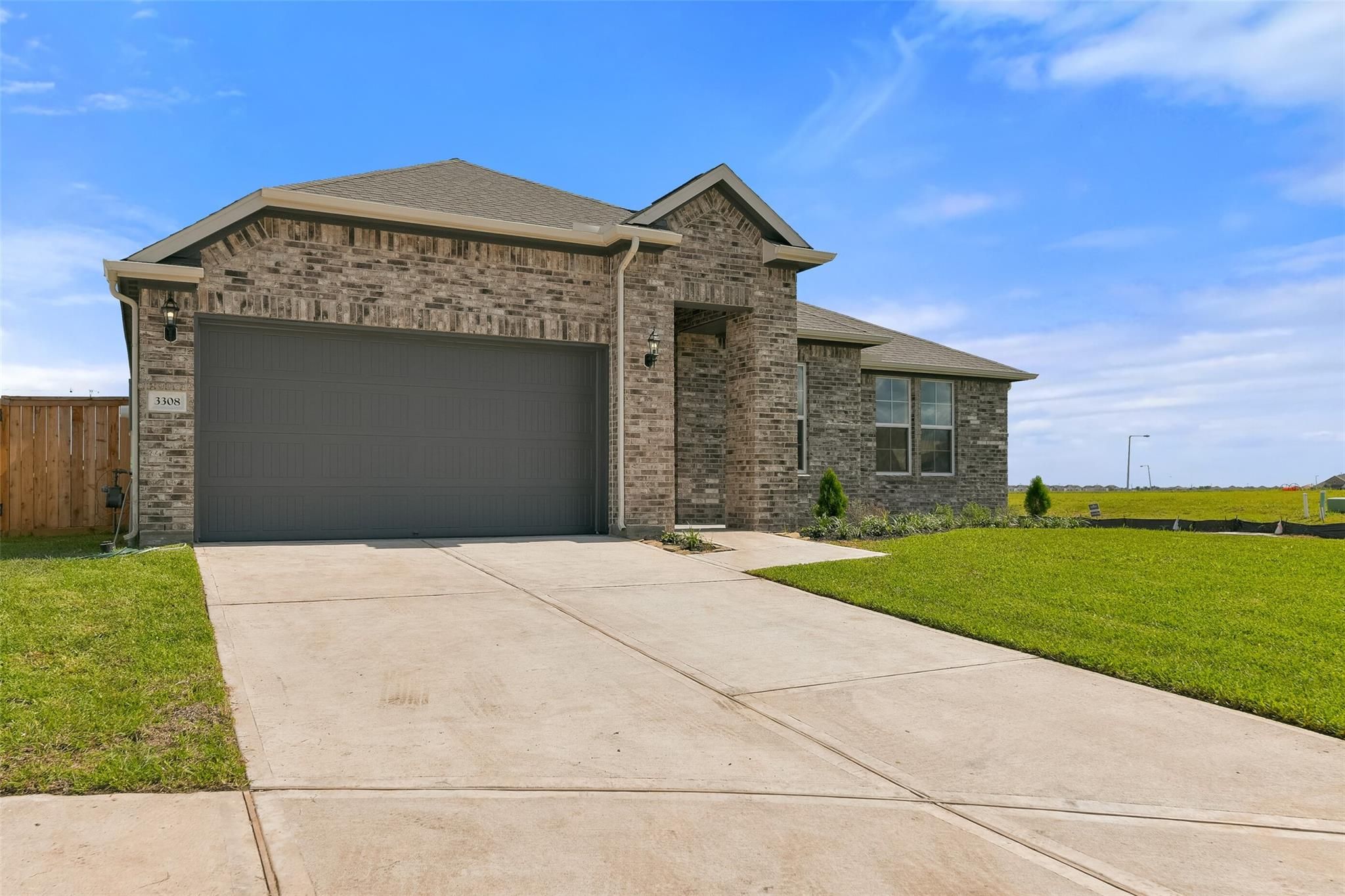 Brick one-story home with 2-car garage, driveway, and lush lawn in Lago Mar, Texas City, Texas - Davidson Homes Edward A