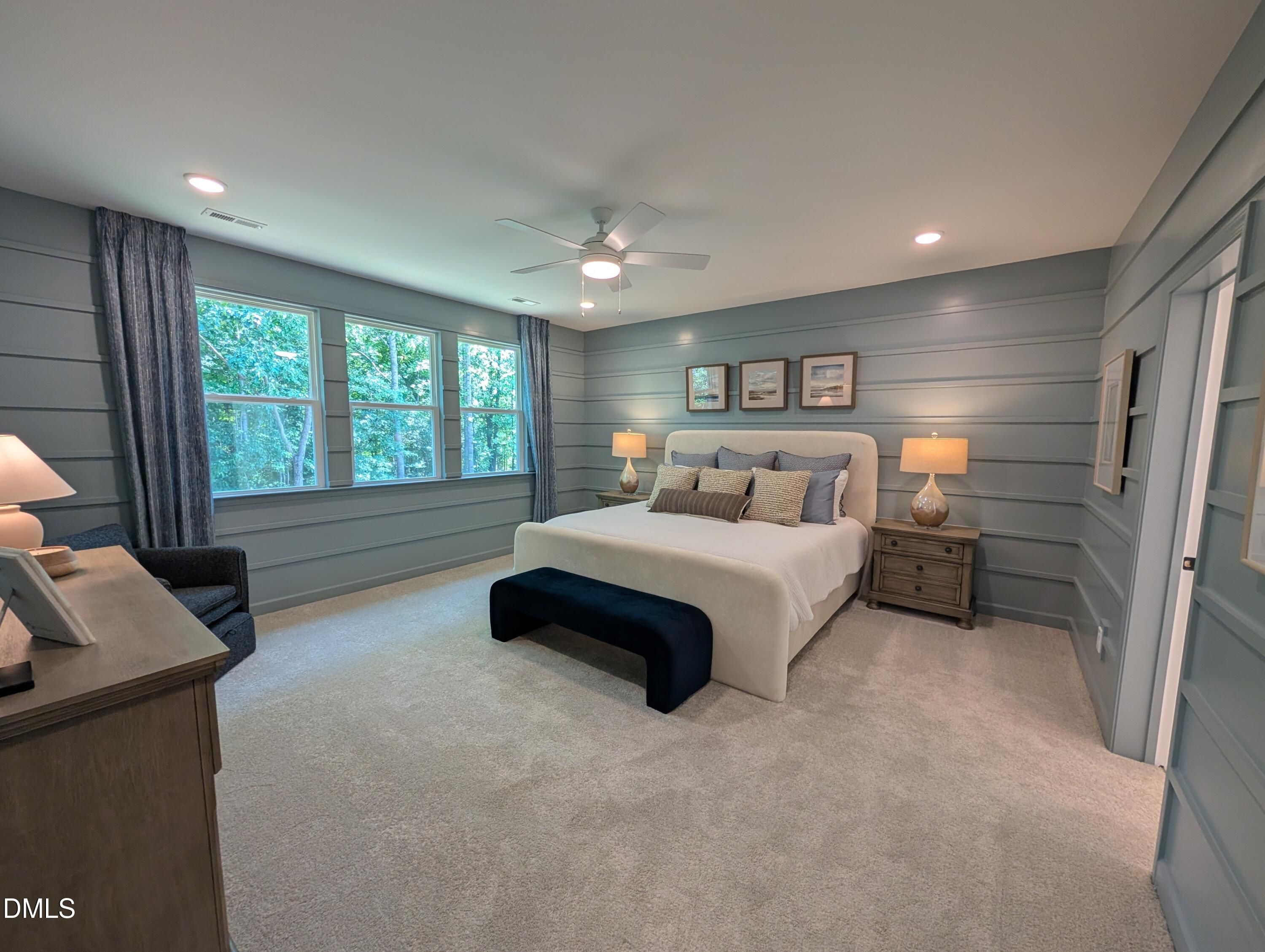 Spacious primary bedroom with blue shiplap walls in The Aspen B floor plan at Wendell Ridge, Wendell, North Carolina.