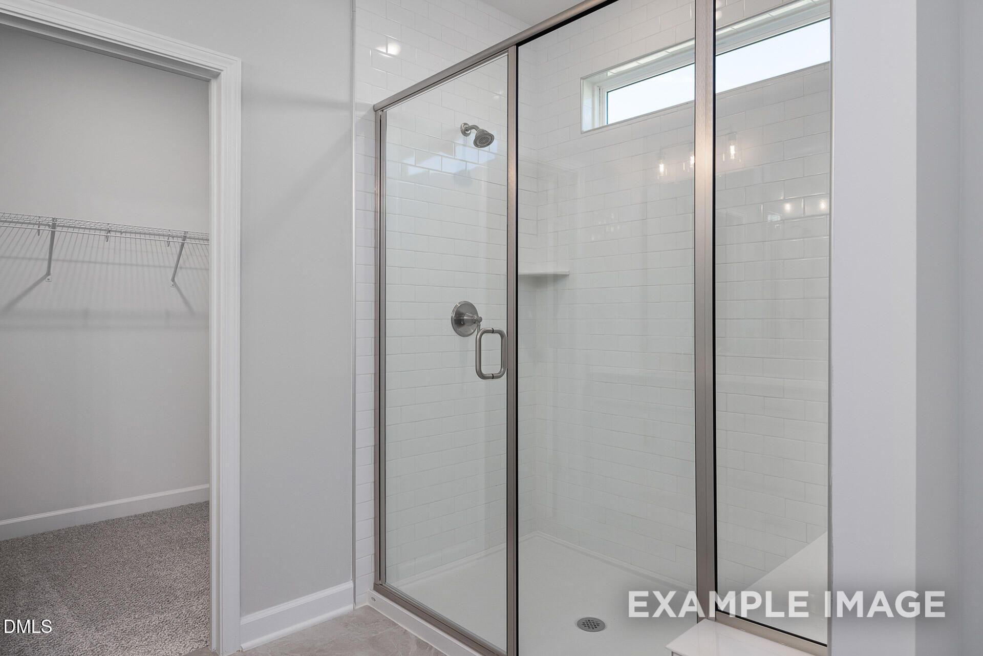 Walk-in tile shower with glass door in The Magnolia A floor plan home at Retreat at North Main in Lillington, NC.