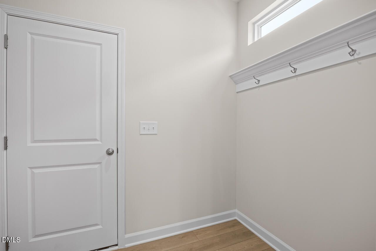 Mudroom area with wall-mounted coat hooks and transom window in The Gavin A floor plan, Gregory Village, Lillington, NC.