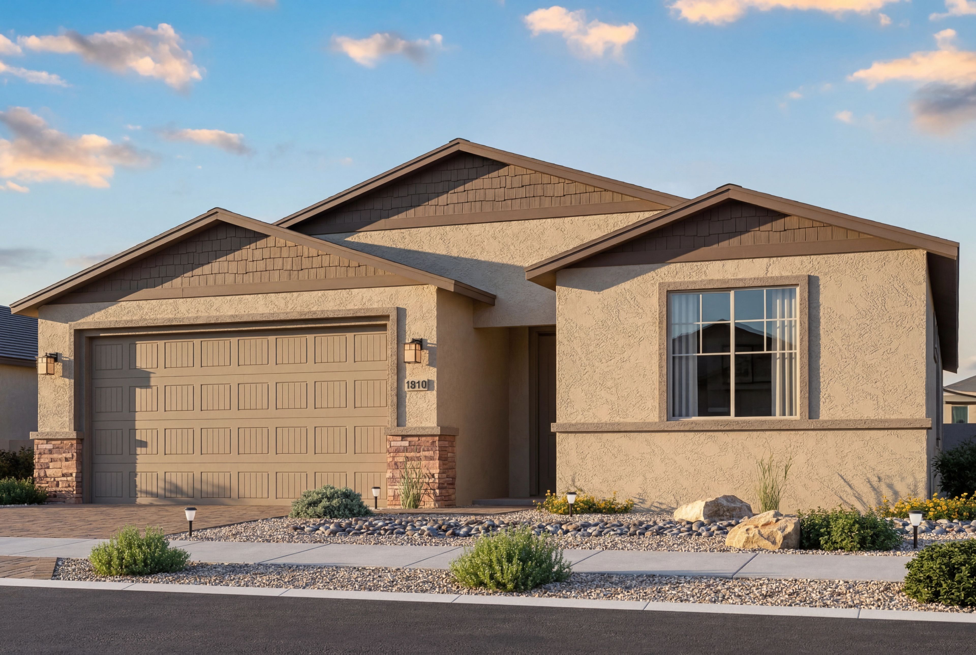 The Inspiration single-story home elevation featuring a 2-car garage, stucco exterior, and stone accents in Prescott Valley.