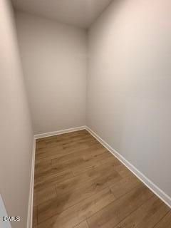 Spacious walk-in closet with wood-look flooring in The Daphne D floor plan at Woodland Crossing, Zebulon, North Carolina.