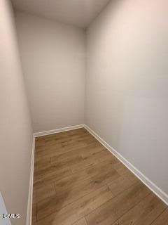 Spacious walk-in closet with wood-look flooring in The Daphne D floor plan at Woodland Crossing, Zebulon, North Carolina.