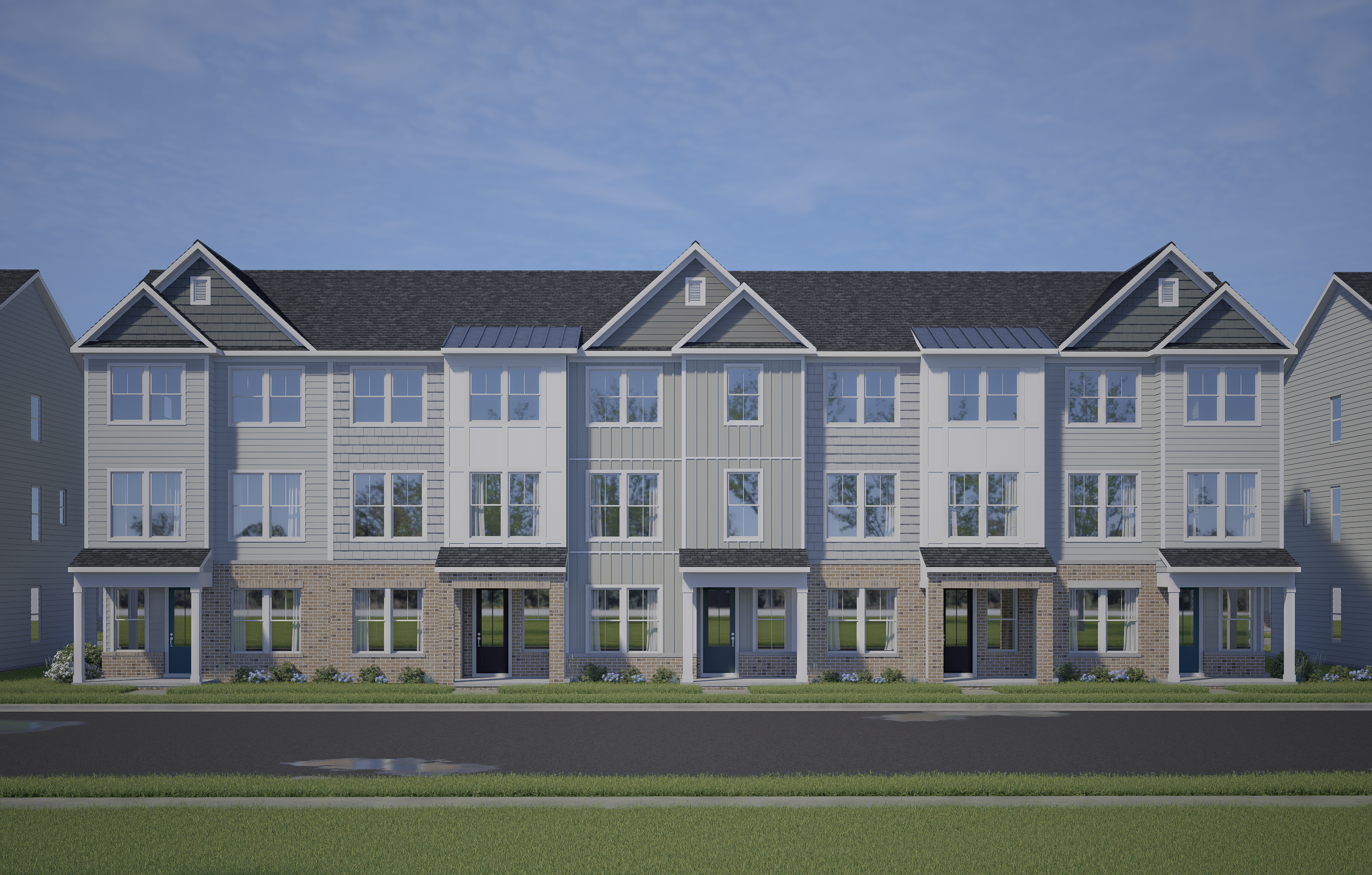 Row of modern townhomes at Forestville Yard in Knightdale NC with covered porches, brick bases and siding