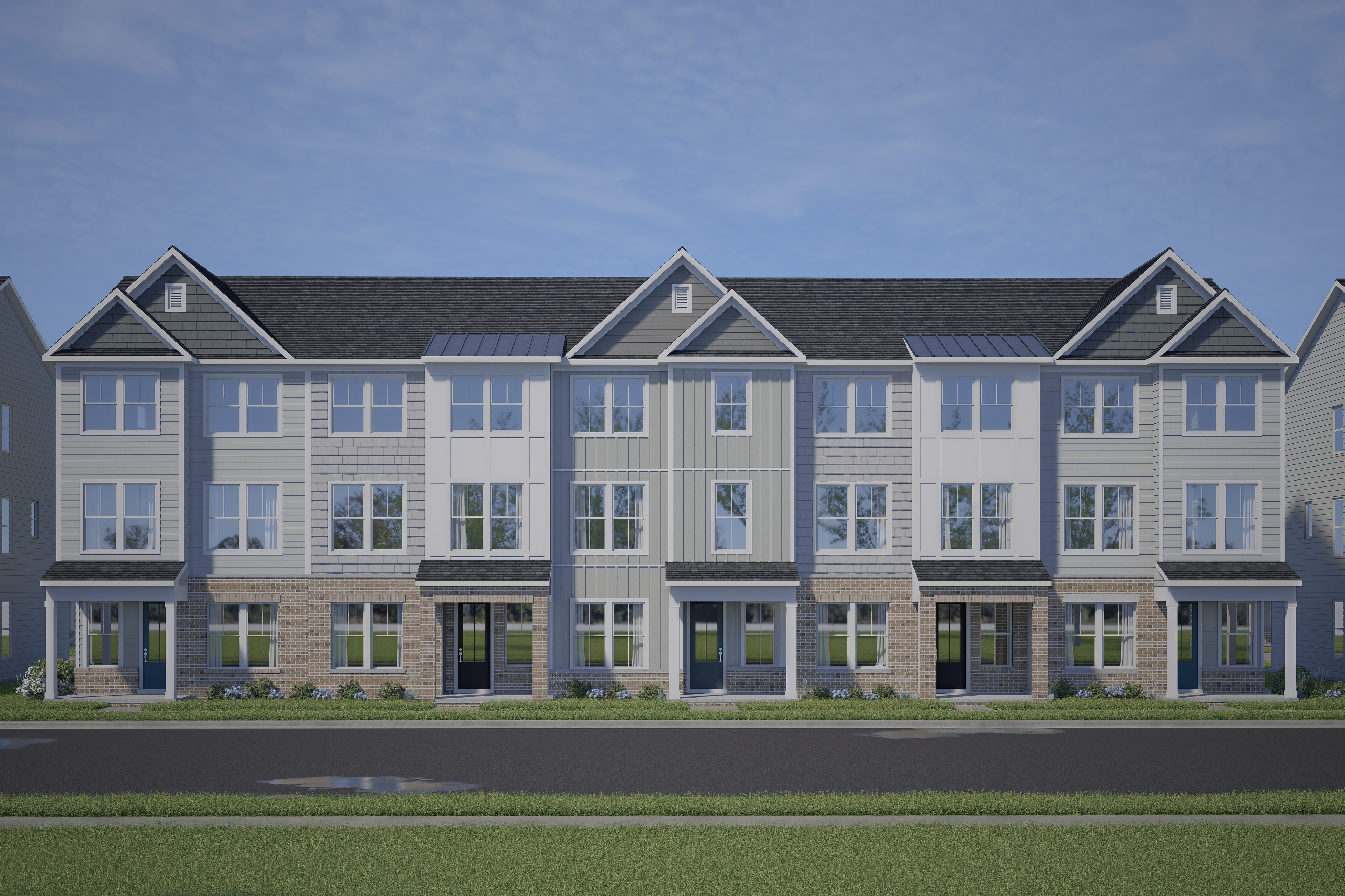 Row of modern townhomes at Forestville Yard in Knightdale NC with covered porches, brick bases and siding