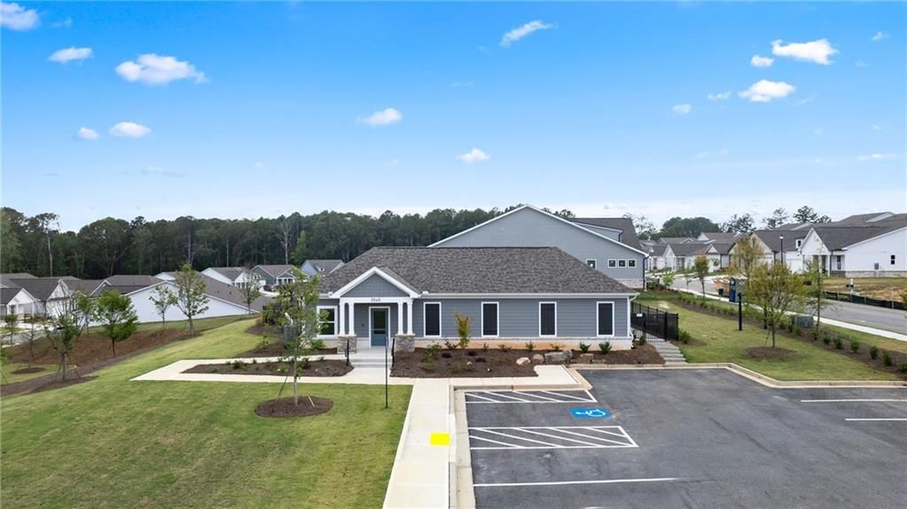 Modern single-story Glenwood A home with gray exterior, 2-car garage, and landscaped parking in Kelly Preserve, Loganville, Georgia