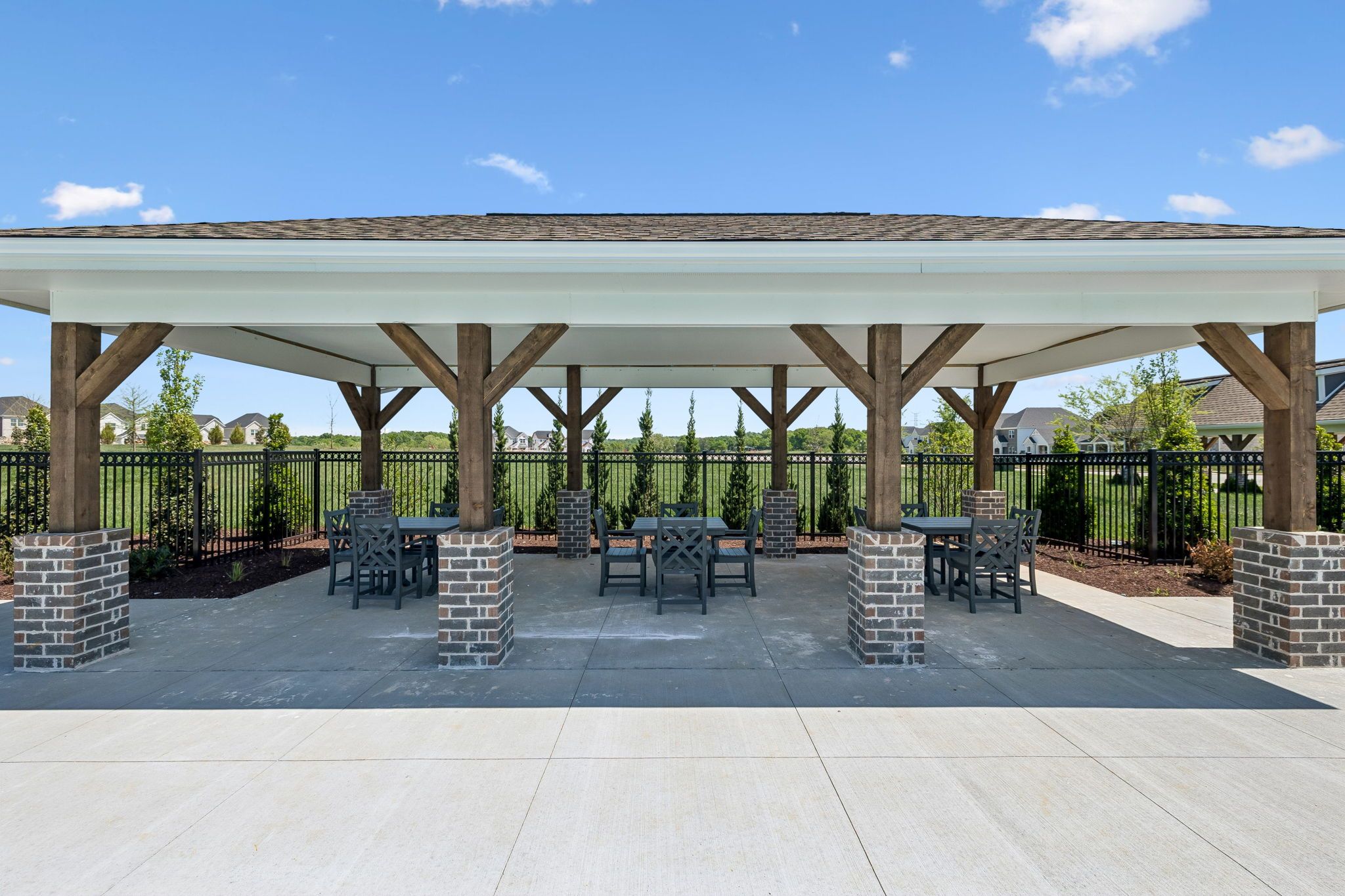 Covered outdoor pavilion with dining seating at Bradshaw Farms in Mt. Juliet, Tennessee by Davidson Homes.