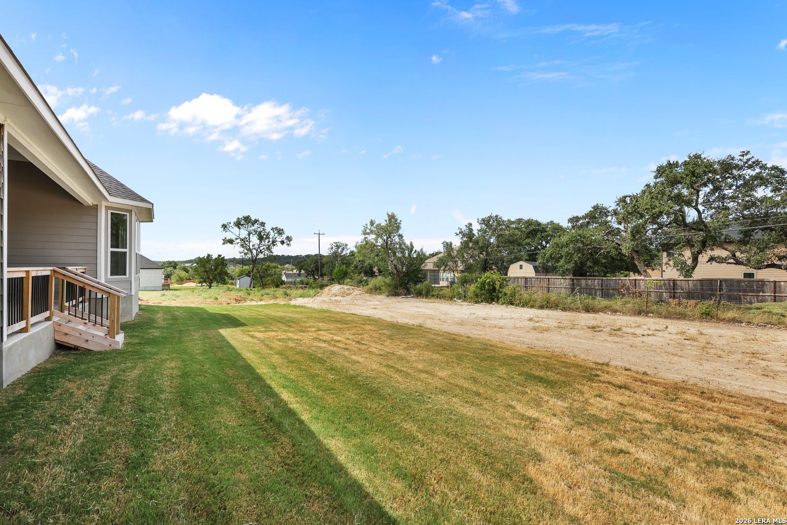 Spacious backyard and exterior deck of The Summerlin B floor plan by Davidson Homes in Potranco Oaks, Castroville, Texas.