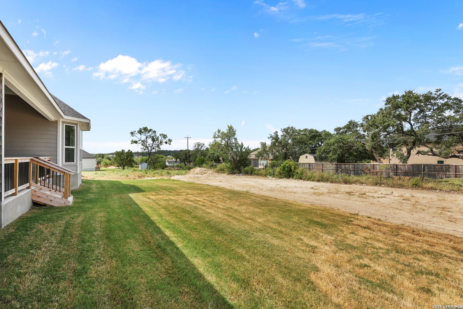 Spacious backyard and exterior deck of The Summerlin B floor plan by Davidson Homes in Potranco Oaks, Castroville, Texas.