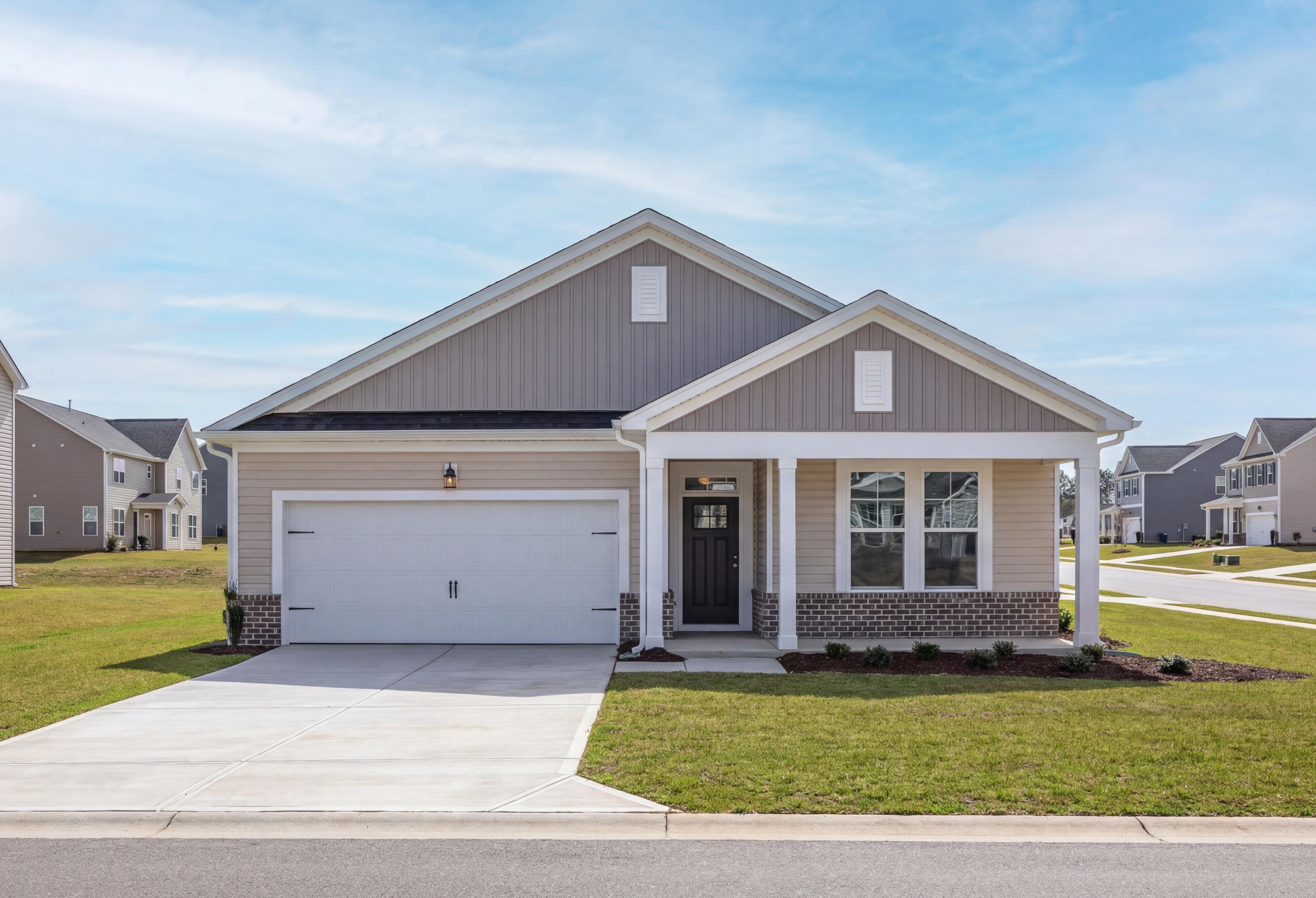 Modern Franklin C single-story home exterior by Davidson Homes in Lillington NC, gray siding, gabled roof, 2-car garage, front porch