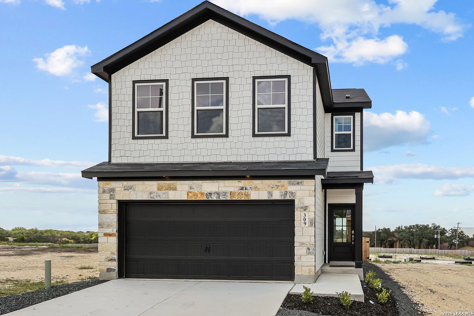 Two-story Gillian B floor plan by Davidson Homes with stone exterior and 2-car garage in Meadows at Oak Creek, San Antonio.