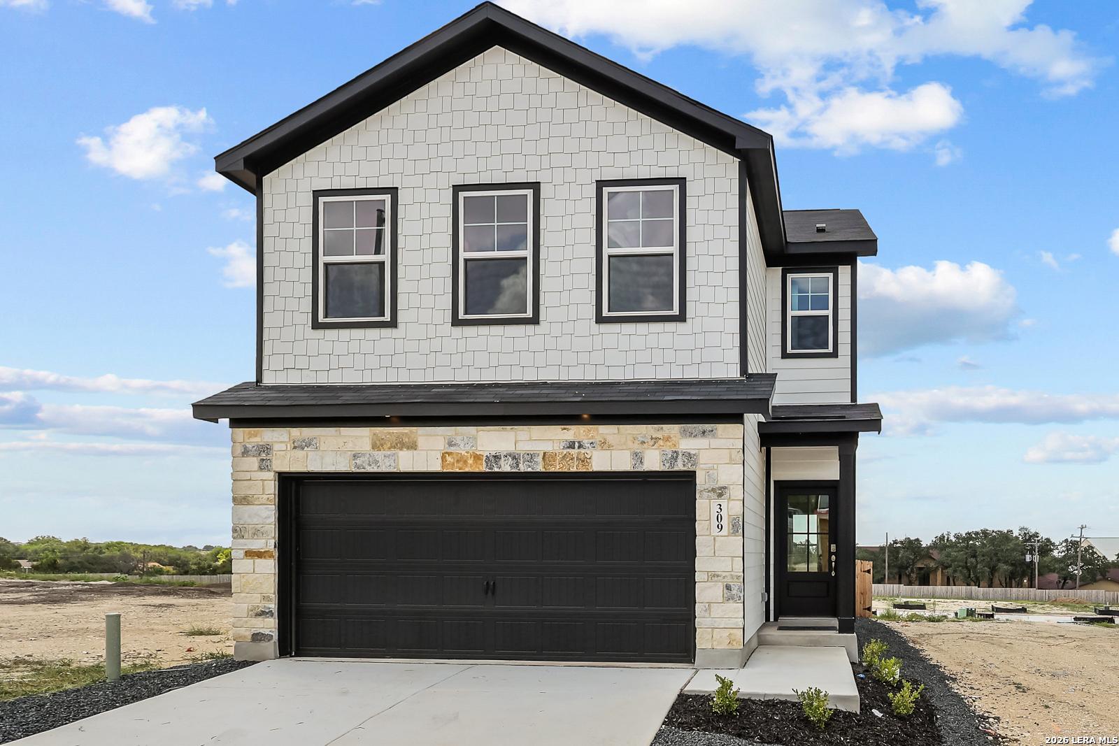Two-story Gillian B floor plan by Davidson Homes with stone exterior and 2-car garage in Meadows at Oak Creek, San Antonio.