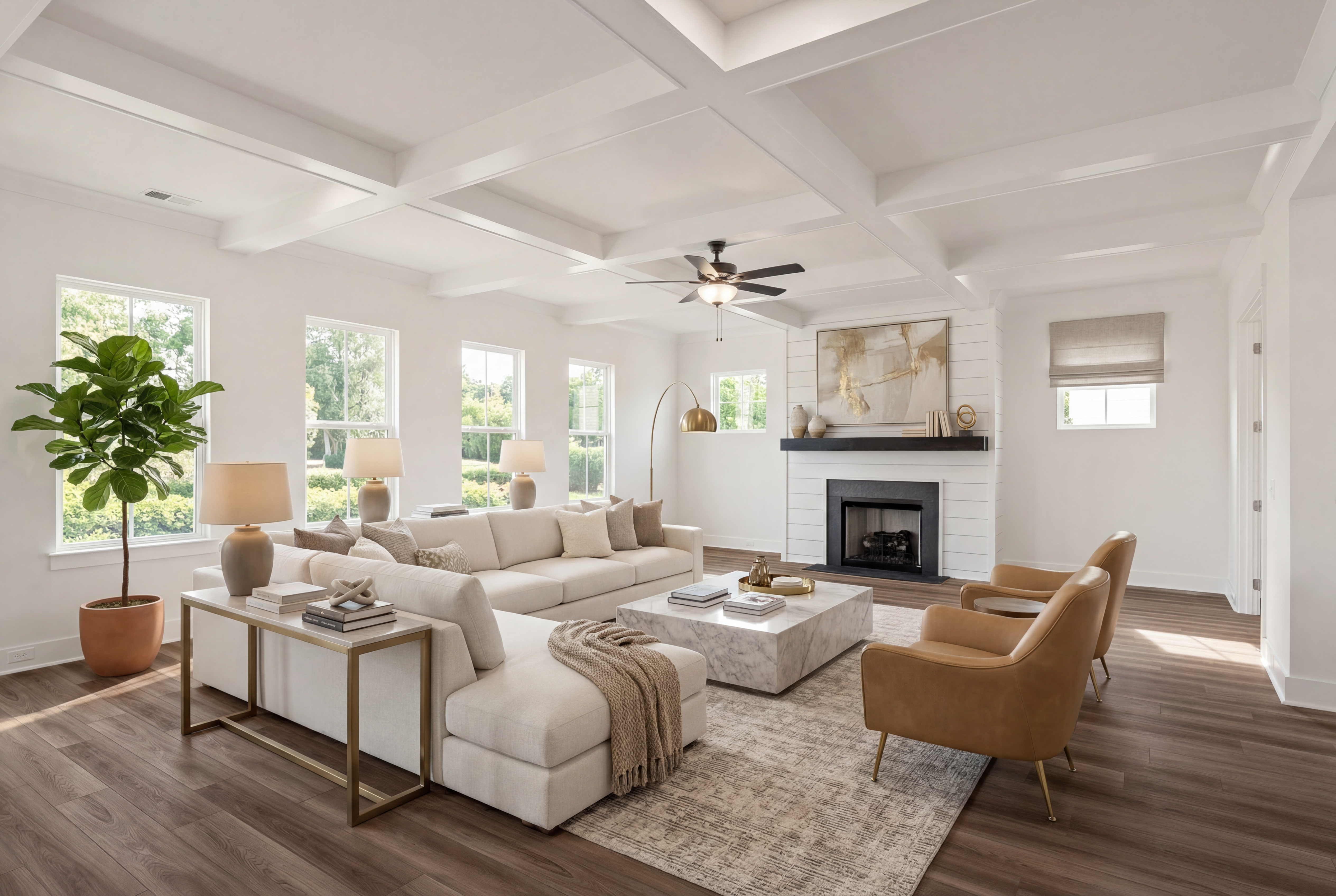 Modern open-concept living room in Shelton Square Murfreesboro TN with white sectional sofa, coffered ceiling, hardwood floors, and gas fireplace