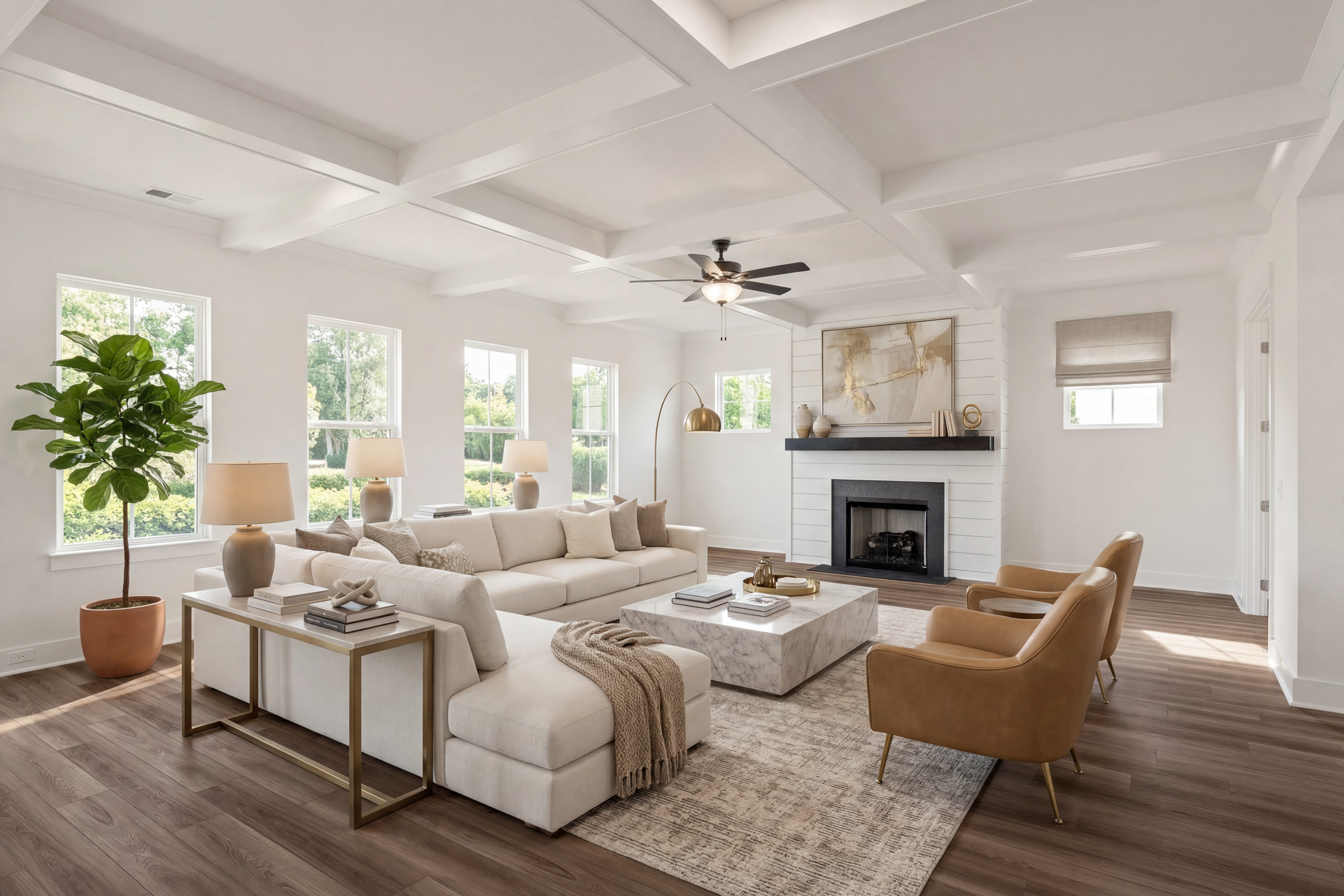 Modern open-concept living room in Shelton Square Murfreesboro TN with white sectional sofa, coffered ceiling, hardwood floors, and gas fireplace