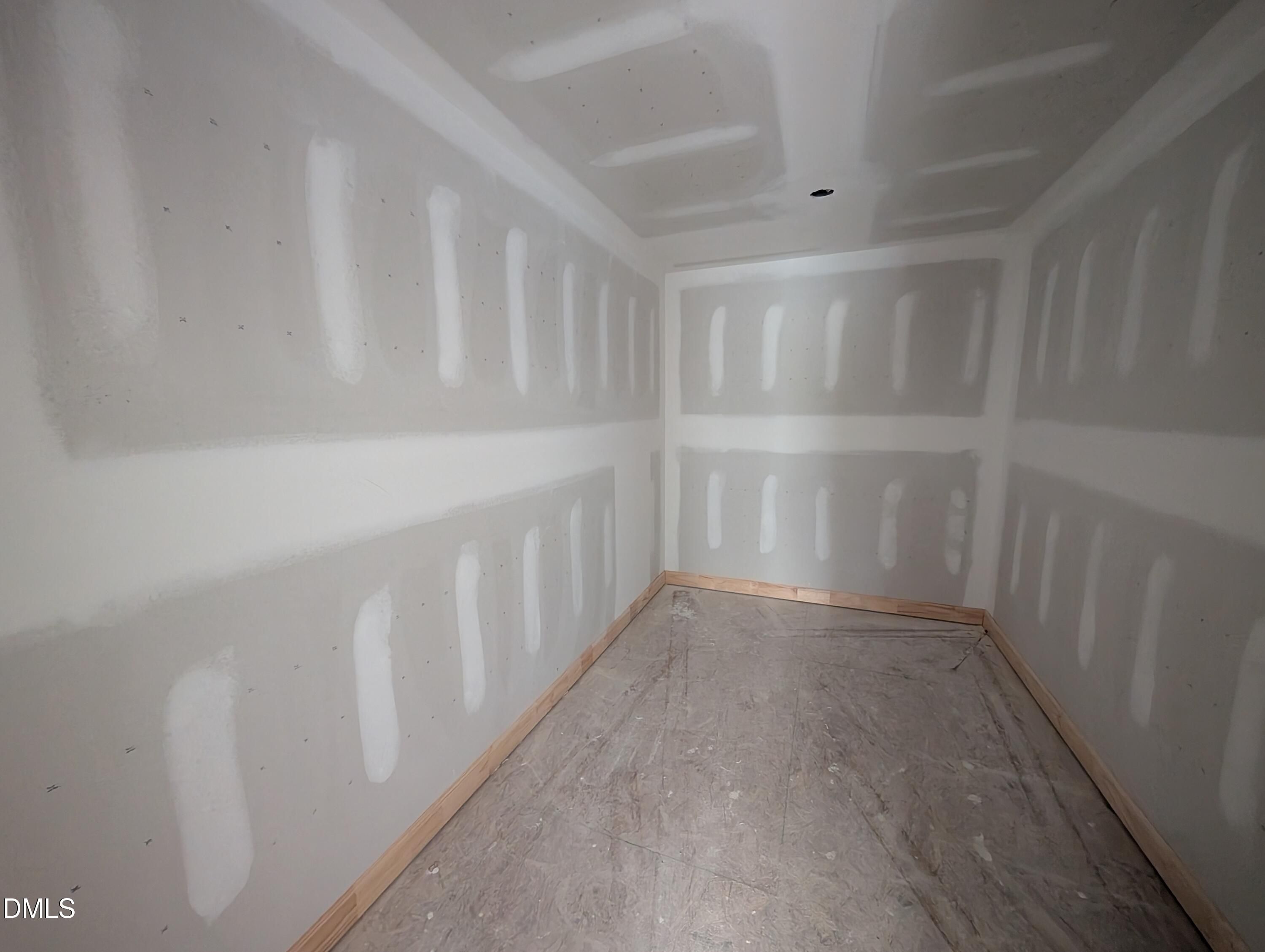 Unfinished room with drywall and taped seams in The Chestnut floor plan at Wendell Ridge, Wendell, North Carolina.