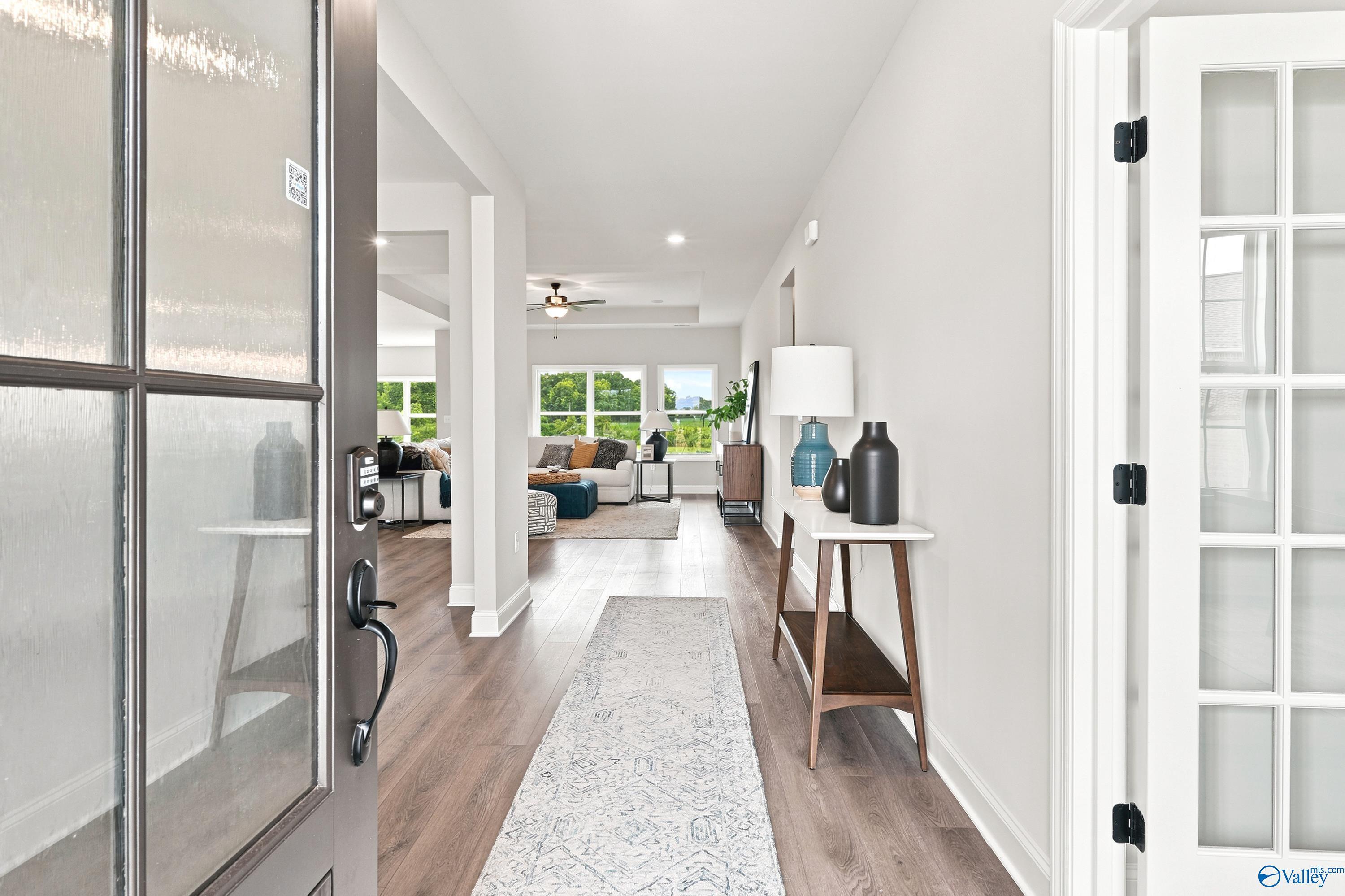 Bright foyer entrance with hardwood floors leading to an open-concept living room in The Finleigh, Riverton Preserve home.