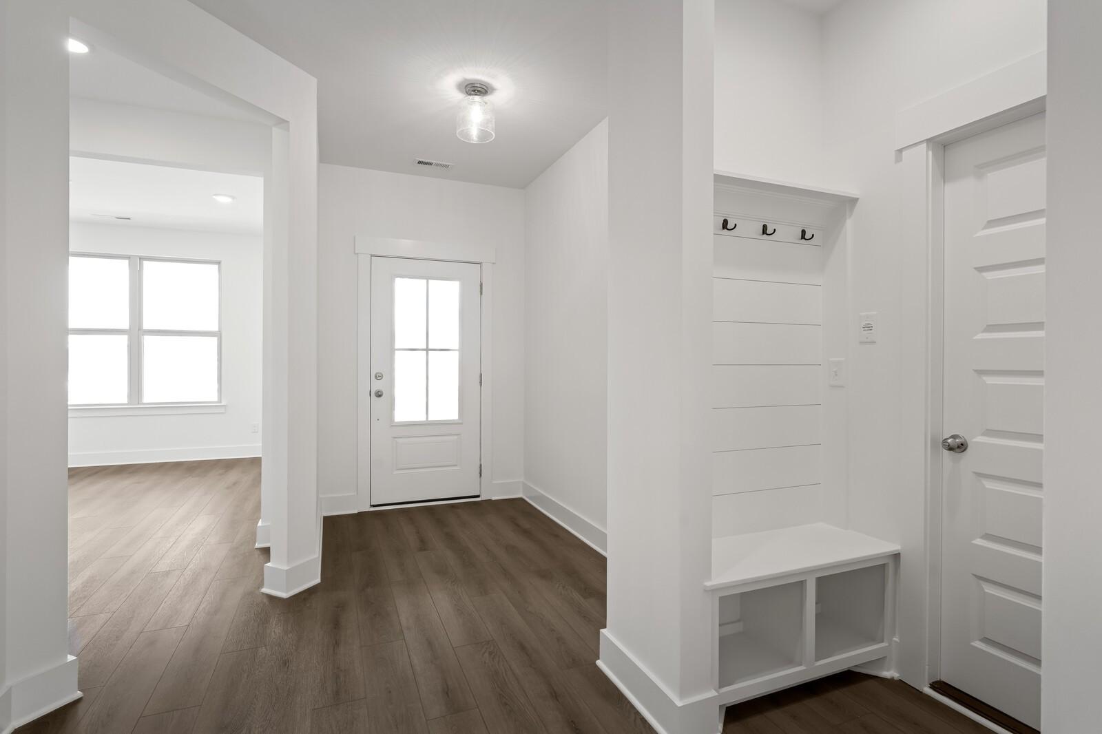 Modern mudroom entry with built-in bench and hooks in The Ridgeport C floor plan at Woods Crossing, Gallatin, Tennessee.