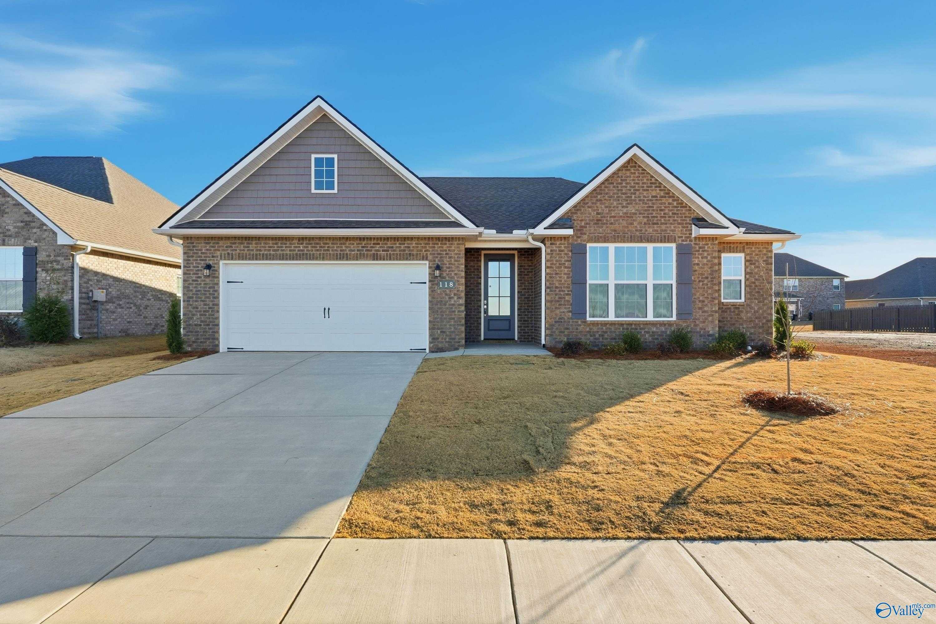 Brick single-story home with 2-car garage, driveway, and gable roof in Kendall Downs, Toney, Alabama by Davidson Homes
