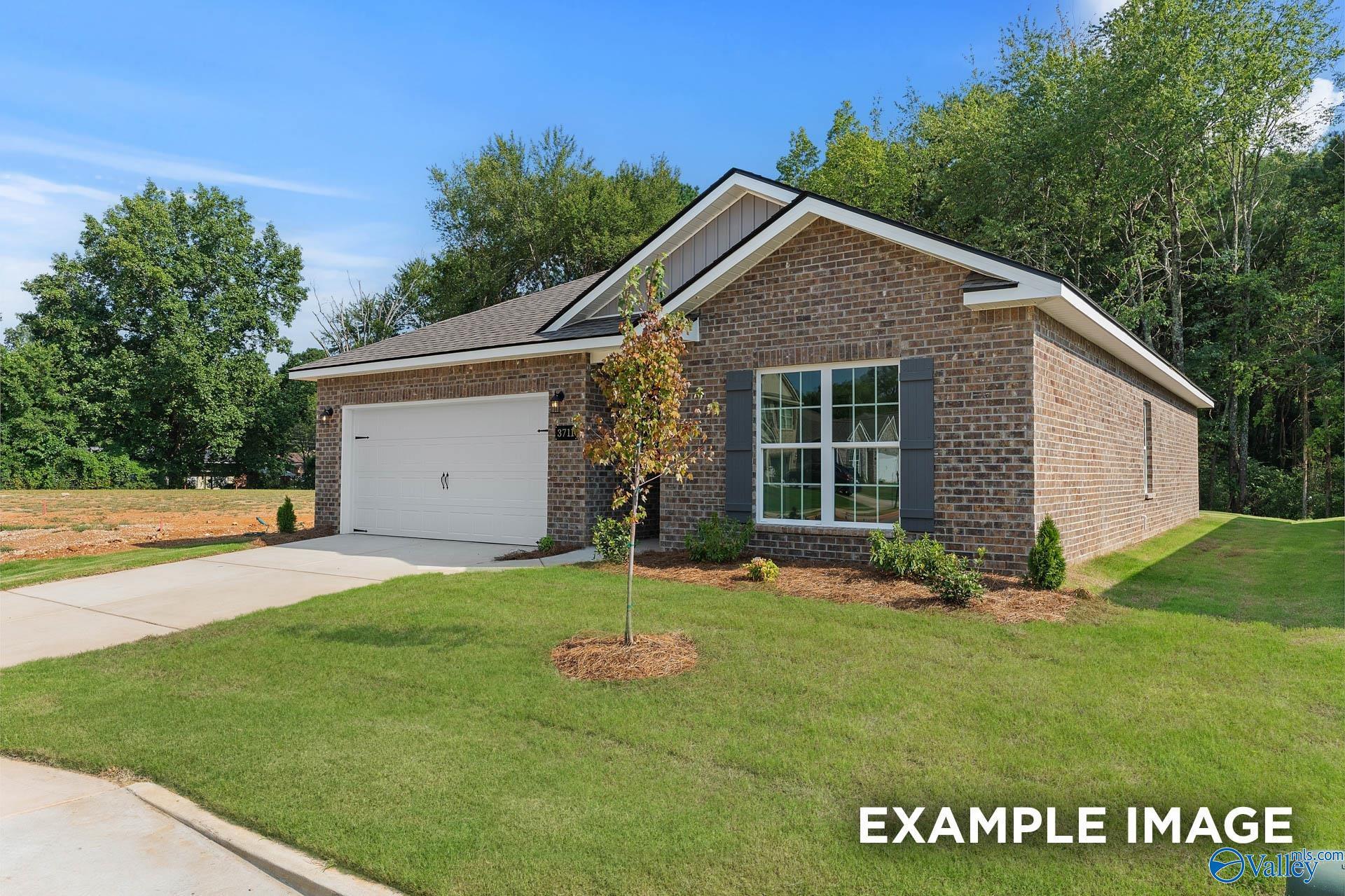 Brick single-story home with red brick exterior, 2-car garage, driveway, and landscaped front yard in Blue Spring, Huntsville, Alabama