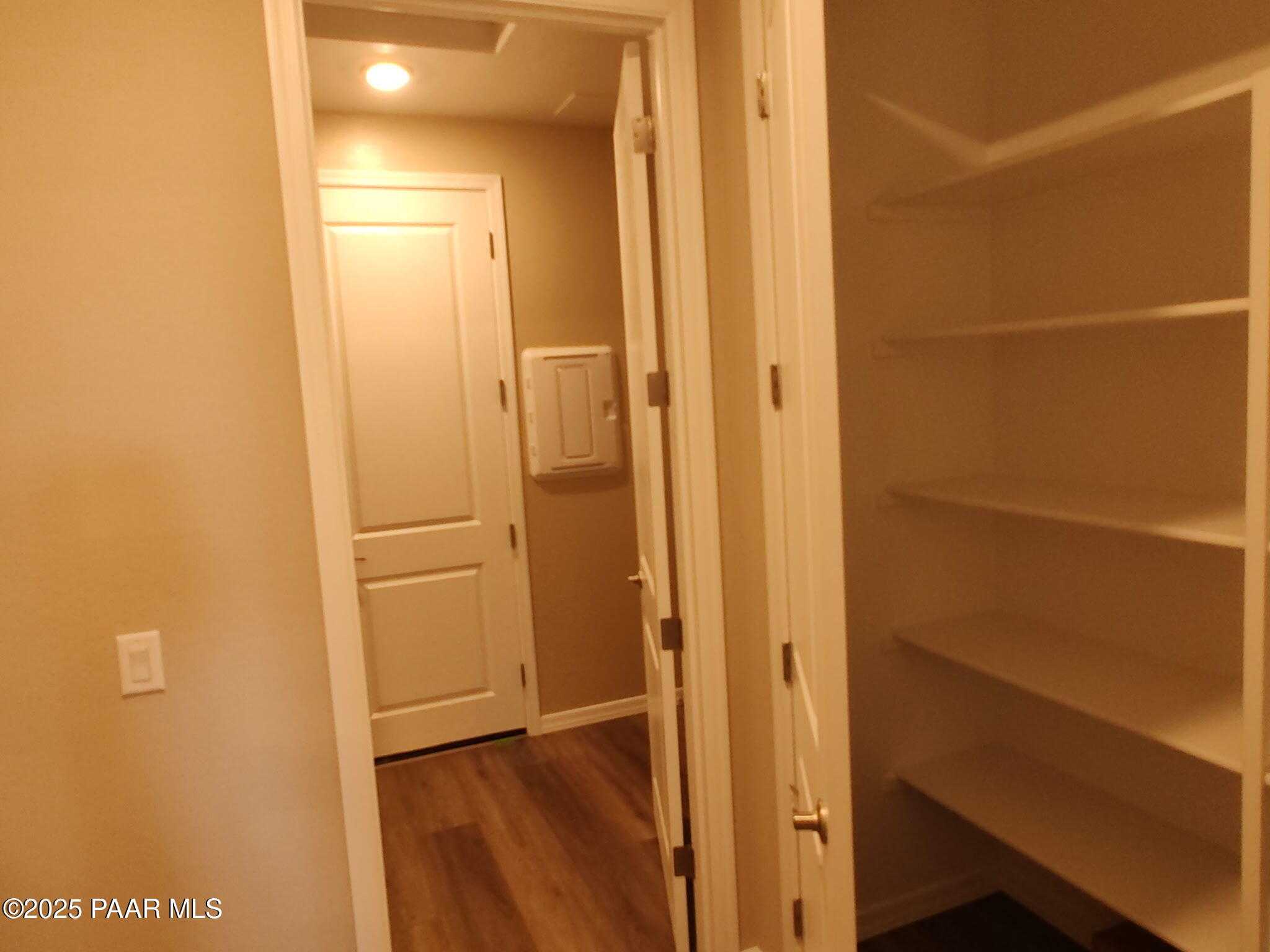 Walk-in pantry with built-in shelves and adjacent laundry area in The Inspiration A floor plan, Davidson Homes, Prescott Valley, AZ