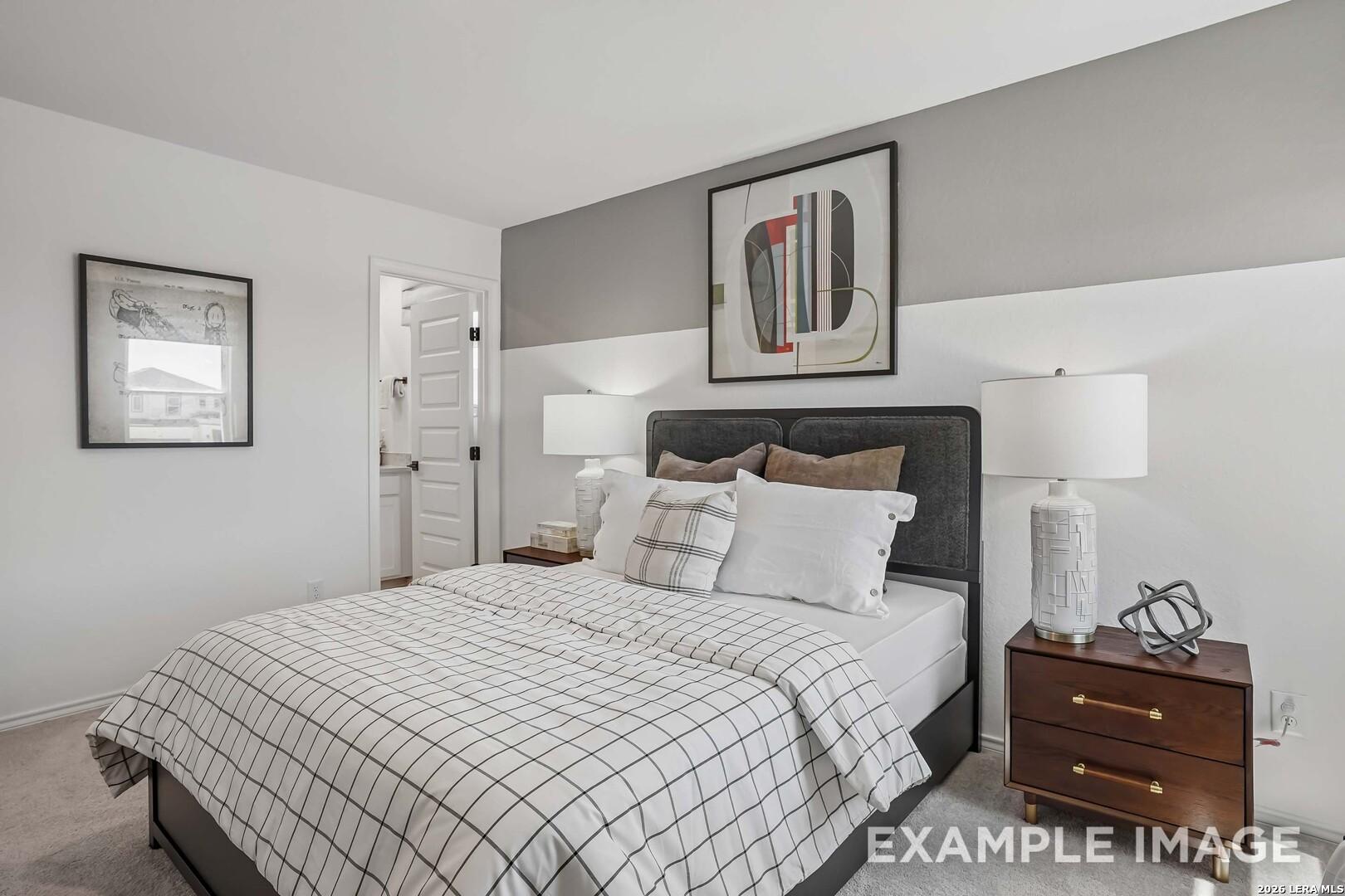 Bright secondary bedroom with dark upholstered headboard and plaid bedding in Davidson Homes' Pinecrest F, Morgan Meadows, San Antonio