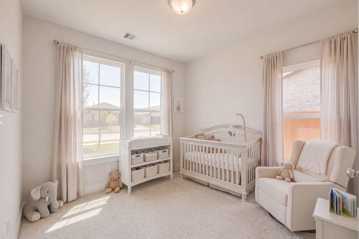 Cozy nursery with white crib, rocking chair, stuffed animals and large windows in The Luna J 4-bedroom home, Sunterra, Katy, Texas
