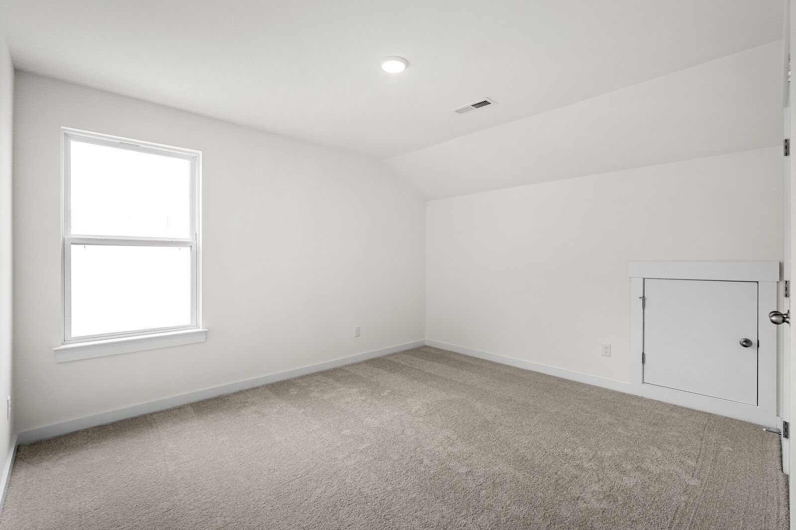 Bright secondary bedroom with sloped ceiling, large window, beige carpet, built-in closet in Davidson Homes The Ridgeport, Gallatin, TN