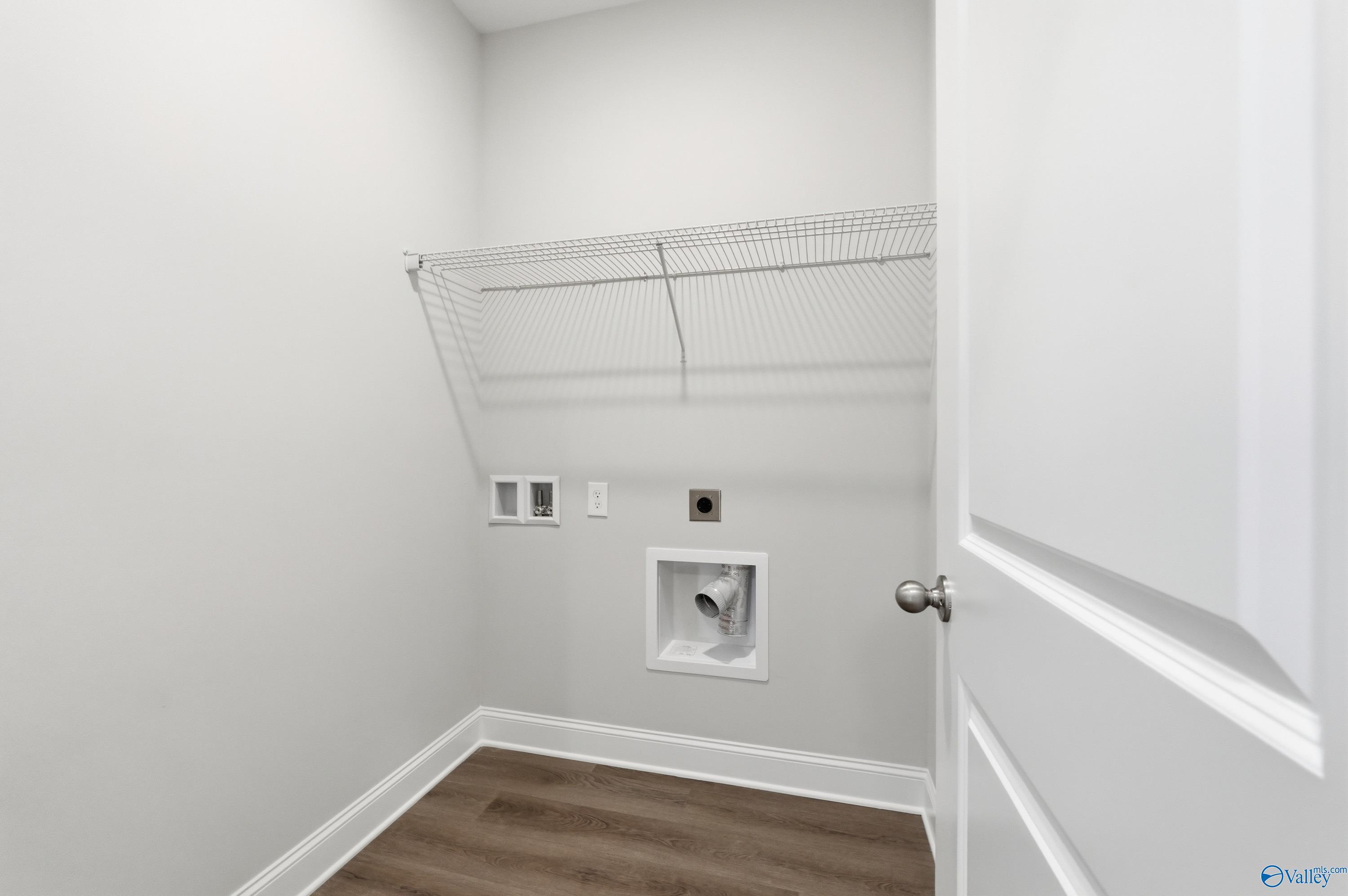 Spacious laundry closet with wire shelving and washer-dryer hookups in Davidson Homes The Asheville C, Huntsville, Alabama